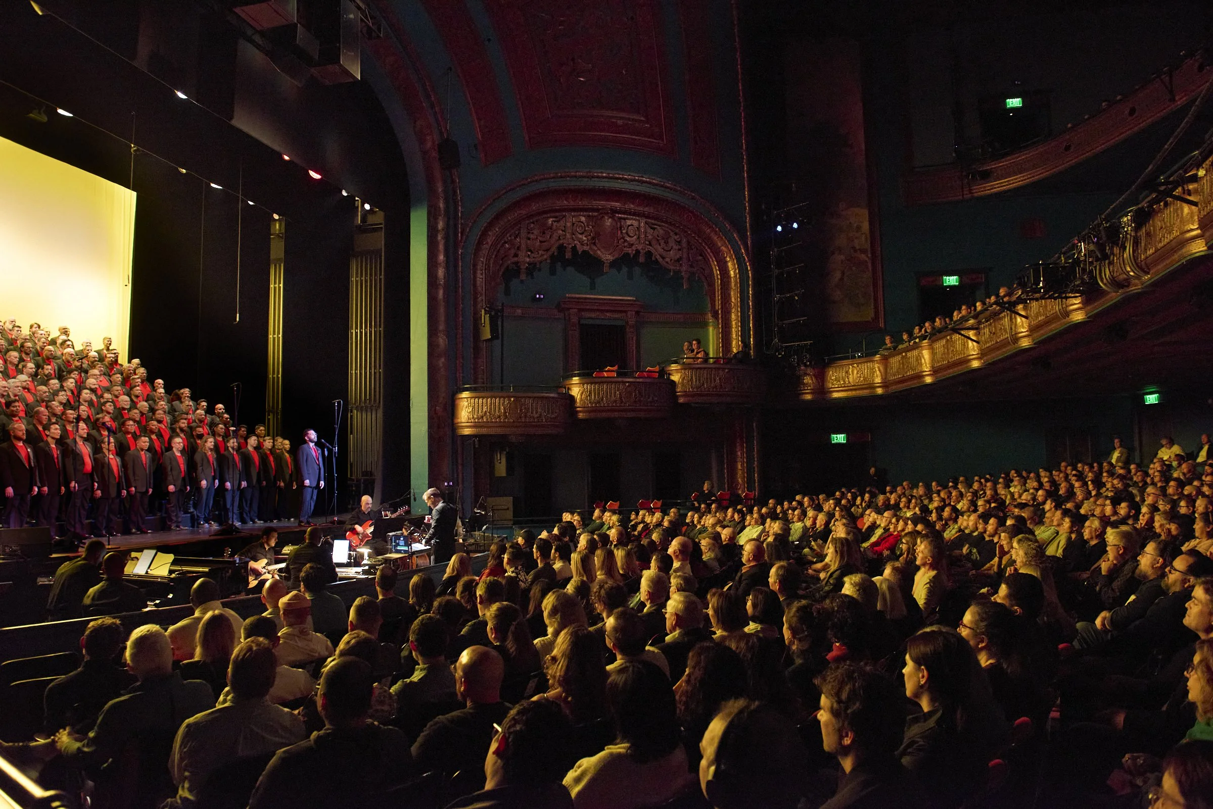 San Francisco Gay Men's Chorus singers performing on stage.