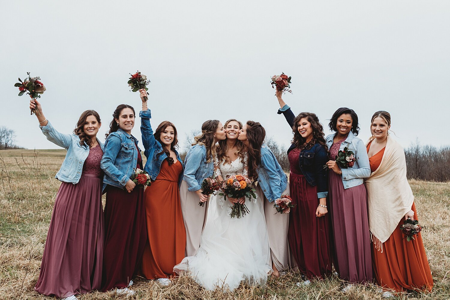 multi racial bride bridesmaids Grove at Kempton wedding photographer Pennsylvania Barn group hug denim jean jackets field