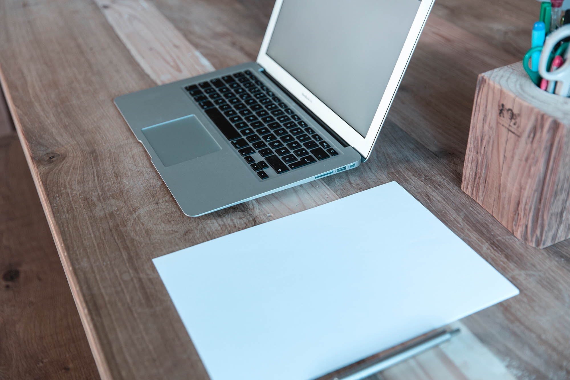 "...my Macbook sat open on his desk with a sparsely scribbled notepad to the right of it."