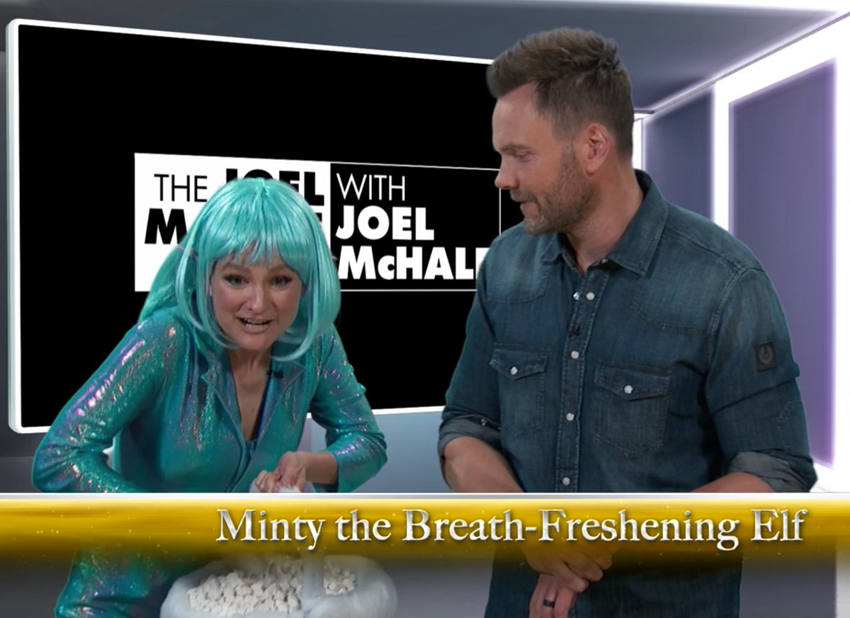 Delaney as her BELOVED Joel McHale Show character, Minty the Breath-Freshening Elf… and Joel