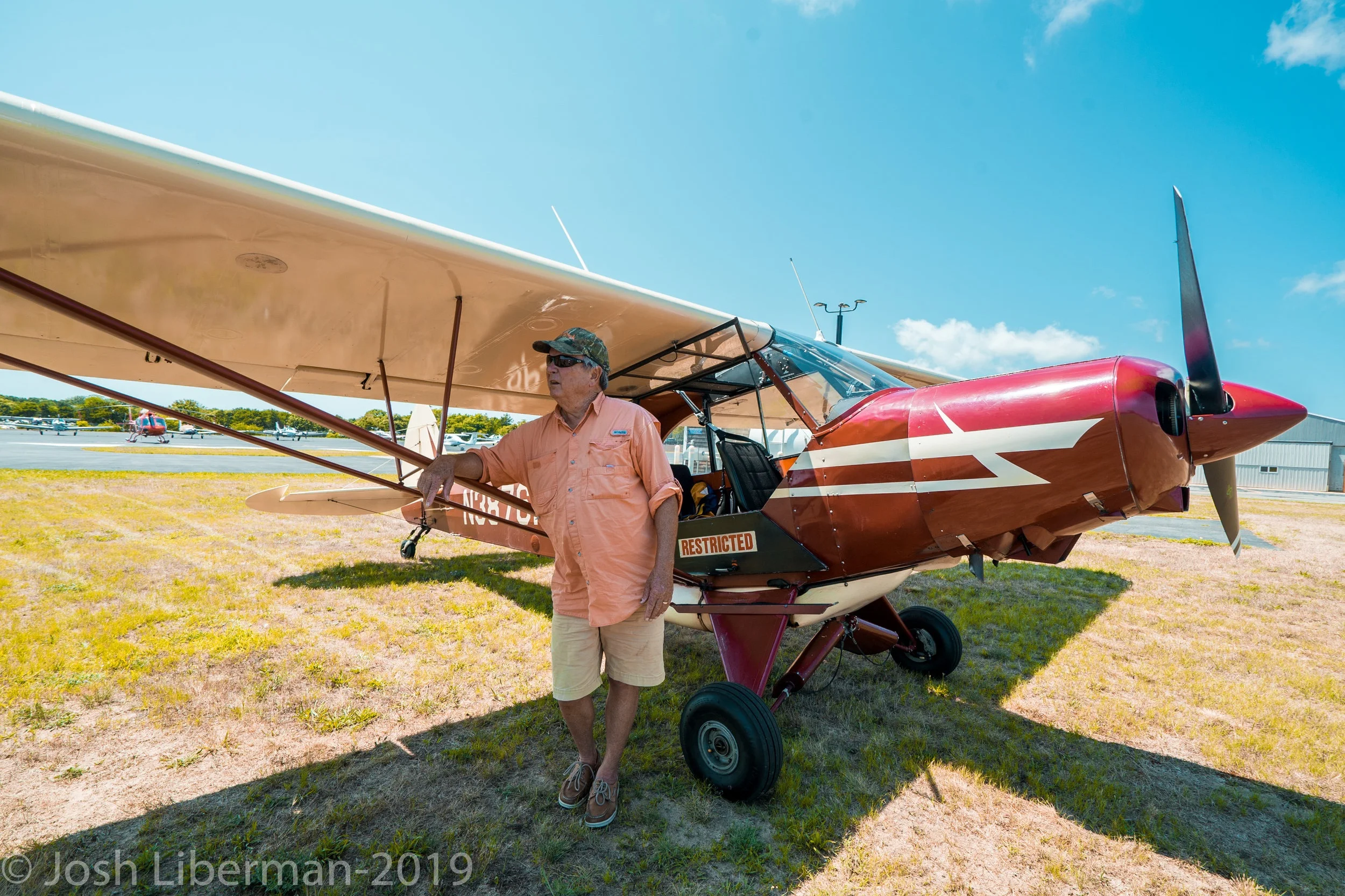 Pilot George Breen stands beside his 1955 Piper Super Cub.