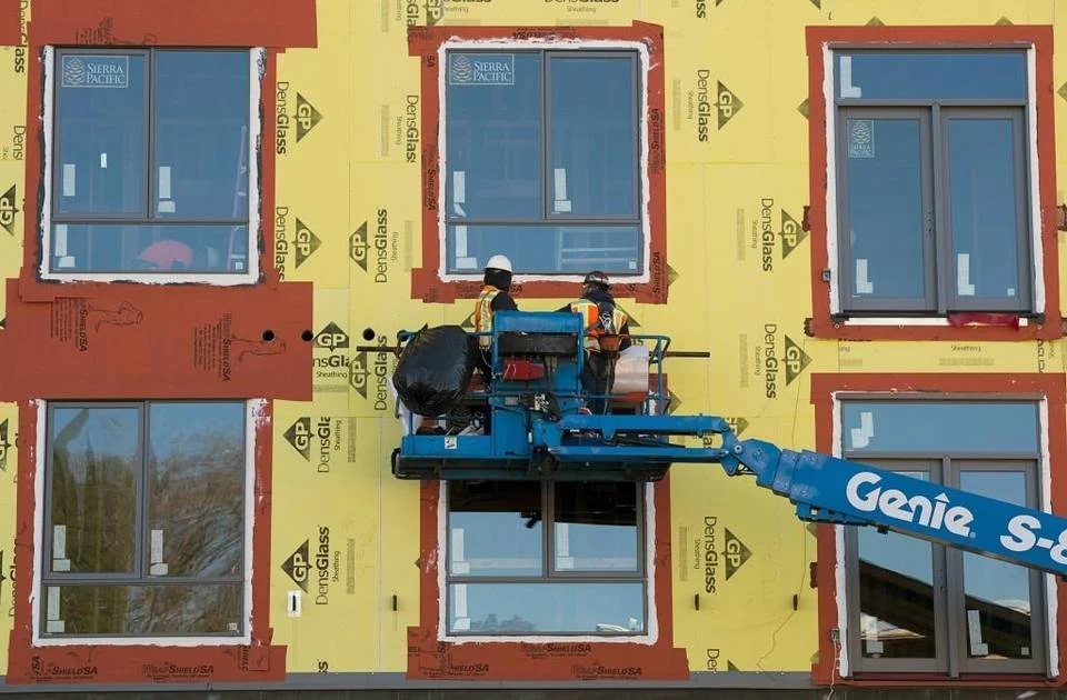 Construction workers work on the Ice Blocks project, which will bring 150 units of high-density housing to the midtown area of Sacramento-Paul Kitagaki Jr