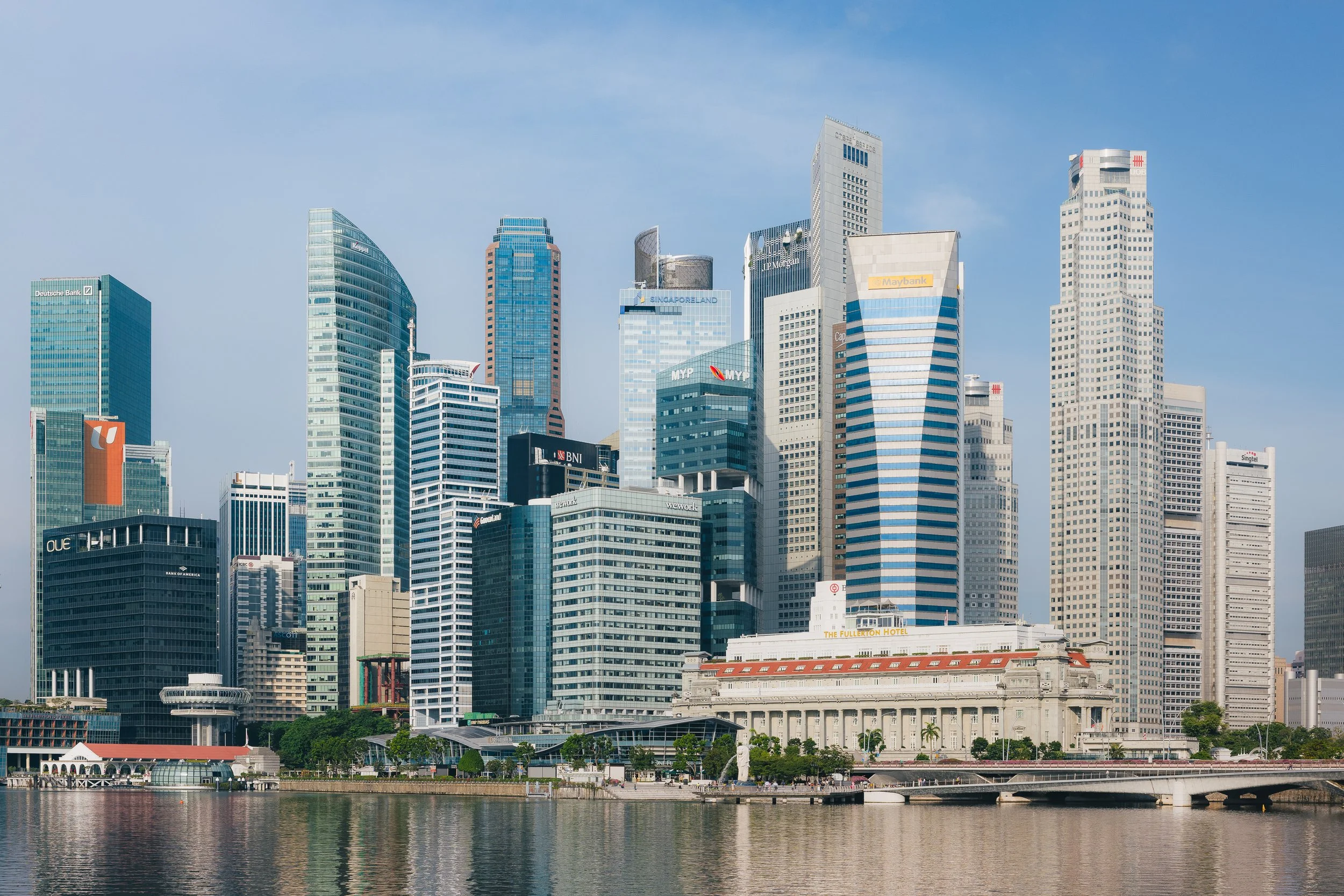 Singapore Land Tower rising above Singapore's Marina Bay skyline, showcasing the regenerated office tower alongside the Fullerton Hotel and Central Business District, photographed for architects 61.