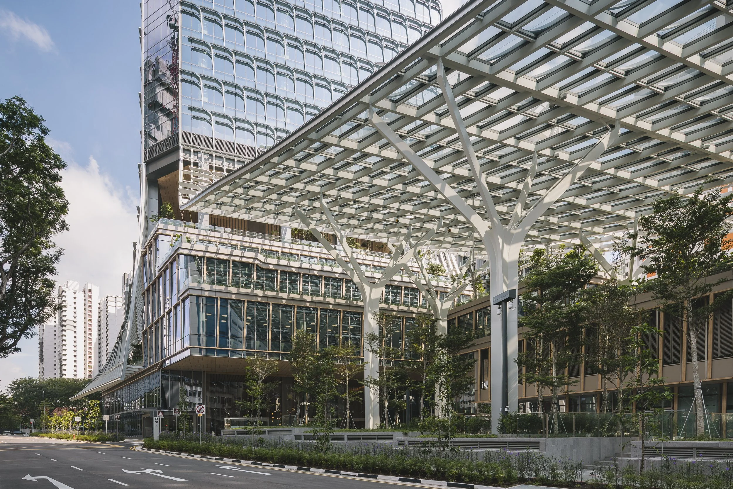 Keppel South Central in Singapore, featuring the office tower, landscaped public plaza and expansive steel-and-glass entrance canopy. Architectural photography by Daniel Koh.