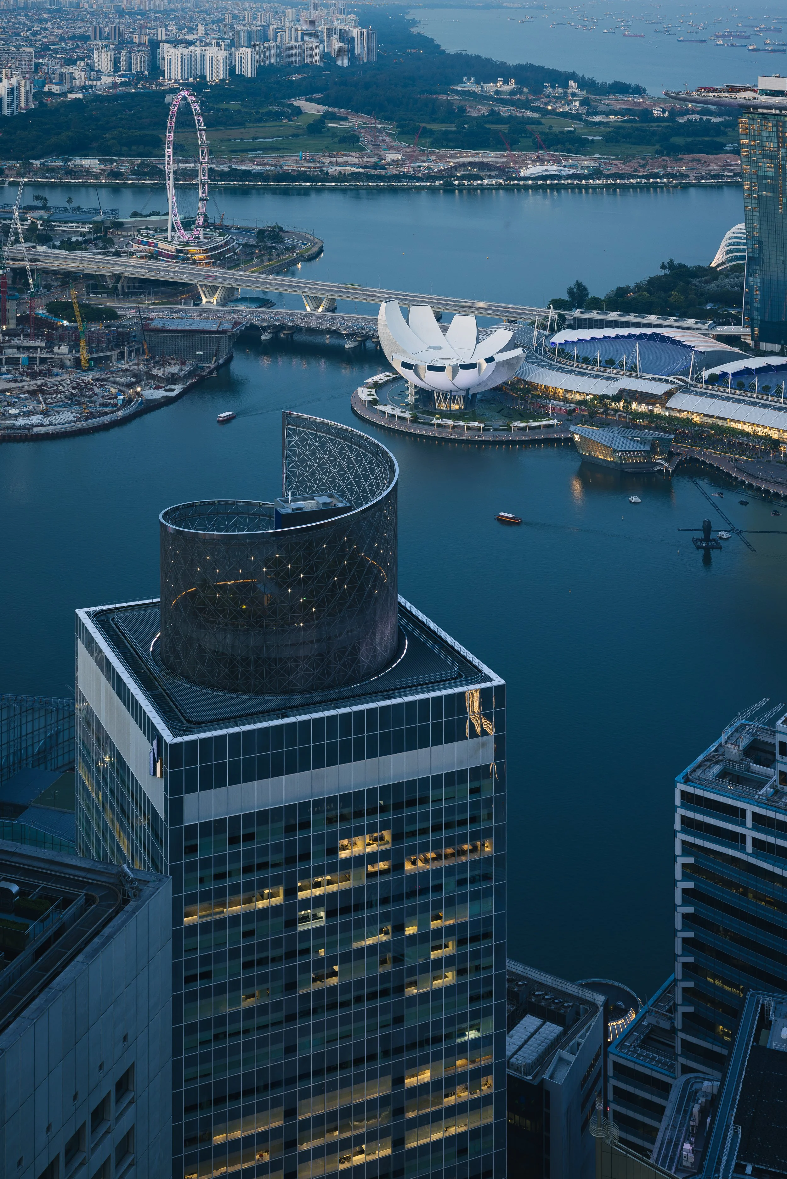 Singapore Land Tower, Singapore, photographed at dusk with panoramic views of Marina Bay, the Singapore Flyer, ArtScience Museum and the Central Business District. Architectural photography by Daniel Koh.