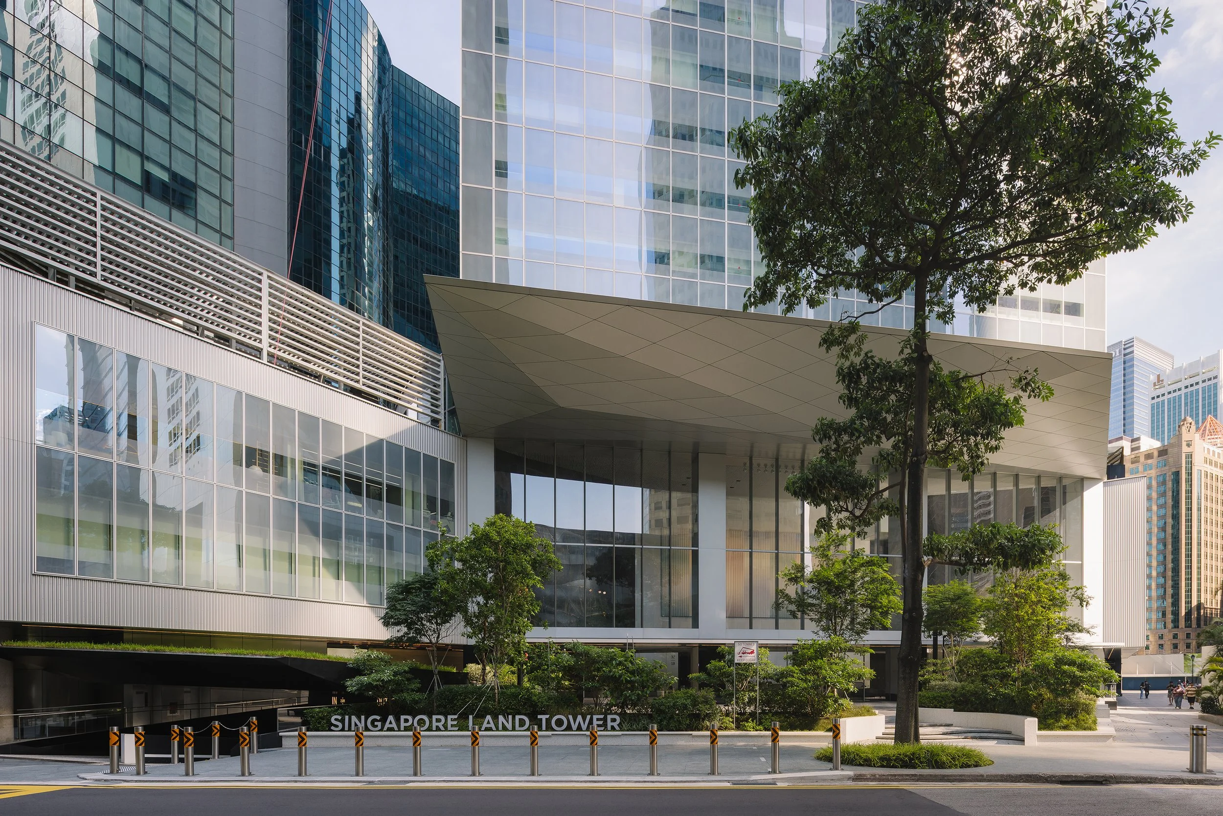 Singapore Land Tower by Architects 61, photographed from the main entrance showcasing the modern façade, landscaped plaza, and surrounding CBD skyline. Architectural photography by Daniel Koh, 2026.