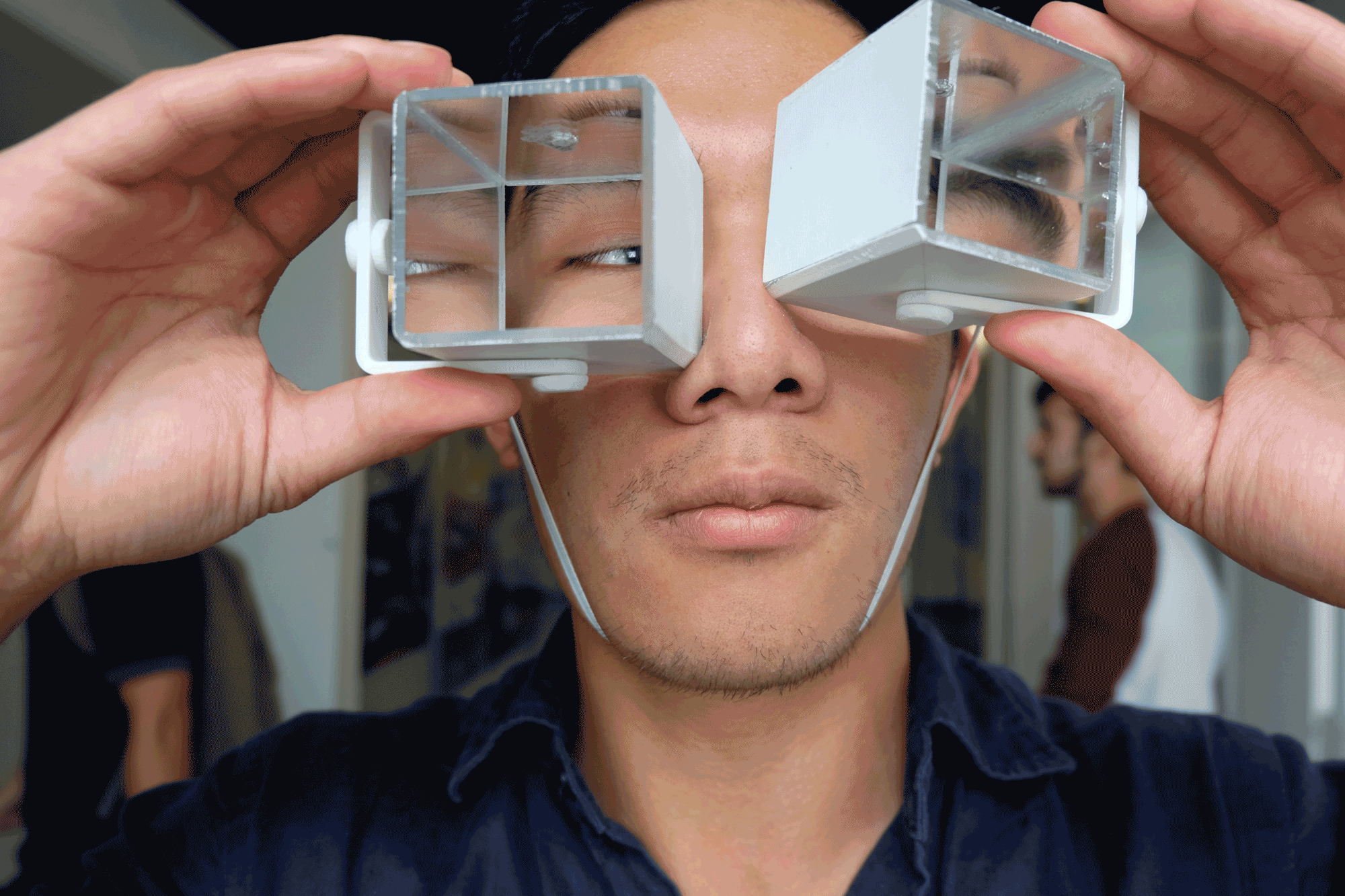 The Reflect frames are 3D printed frames with a head band, elastic chin strap, and two hollow rectangular prisms made of mirrored acrylic. The mirrored prisms sit against the user's face and can easily be swiveled independently of each other. The frame system lets the prisms swivel on both vertical and horizontal axes to give the user a brand new field of view. 