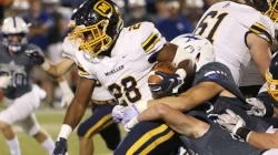 Chrys Watkins running through St.X photo by Chris Malone
