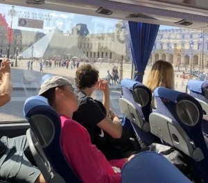 Photo taken by Davis Bianchini of Brock Rumpke sleeping on the bus in front of the Louvre Museum.