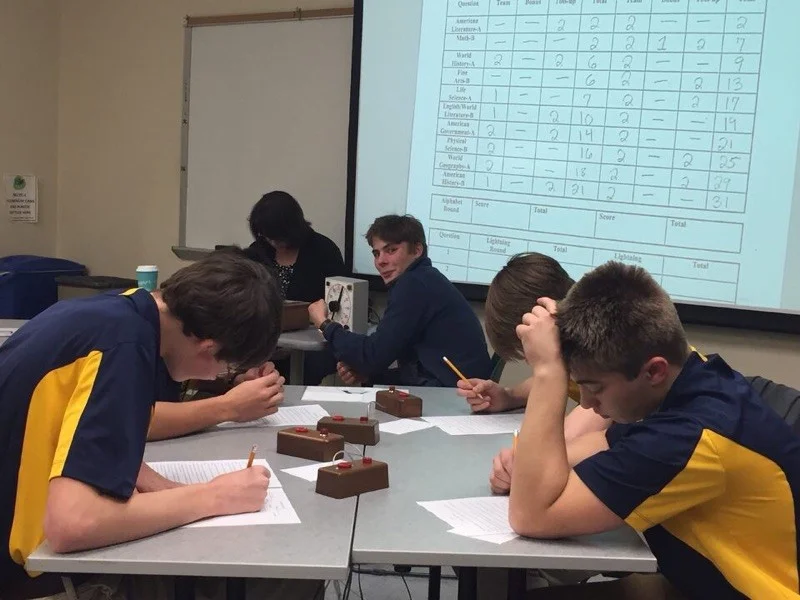 T.J Cracas, Greyson Wesley, Hunter Haas, and Nate Steffan working hard, while Peyton Bambauer cheers on. Photo Adam Riesenberger