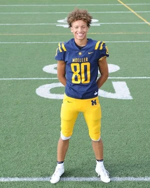 Max Land on the football field by Maxwell Land