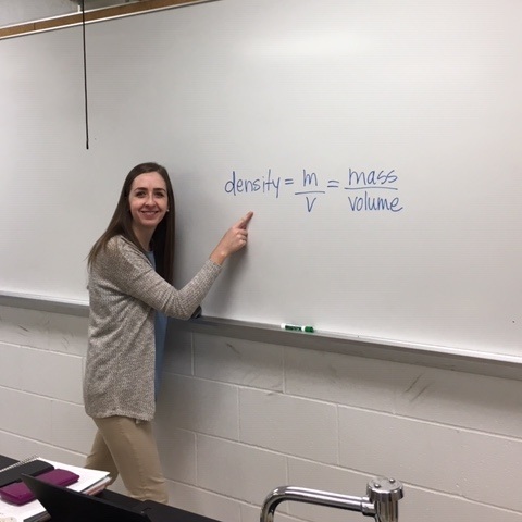 Ms. Ernst proudly showing off the formula for density by Ryan Stacey