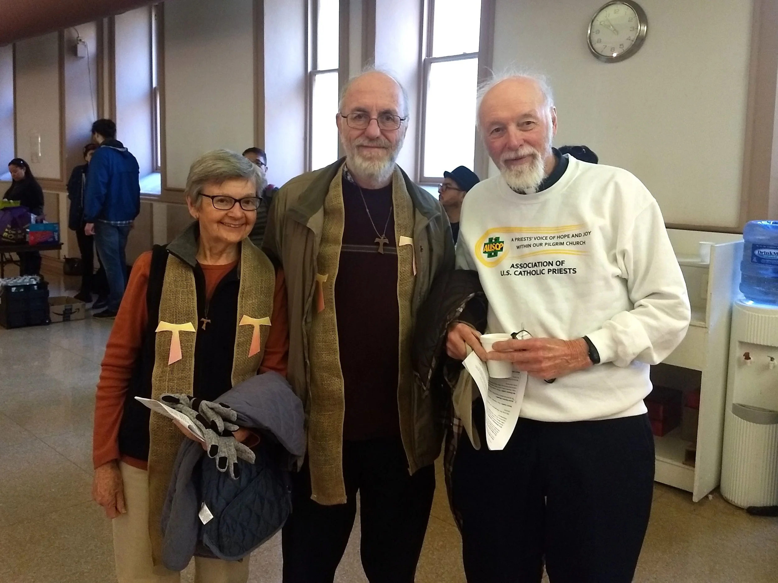 Sister Maria Lucey, associate director of the Franciscan Action Network, Patrick Carolan, FAN executive director, and Father Bernard Survil, pose before departing a staging area for the Catholic Day of Action.