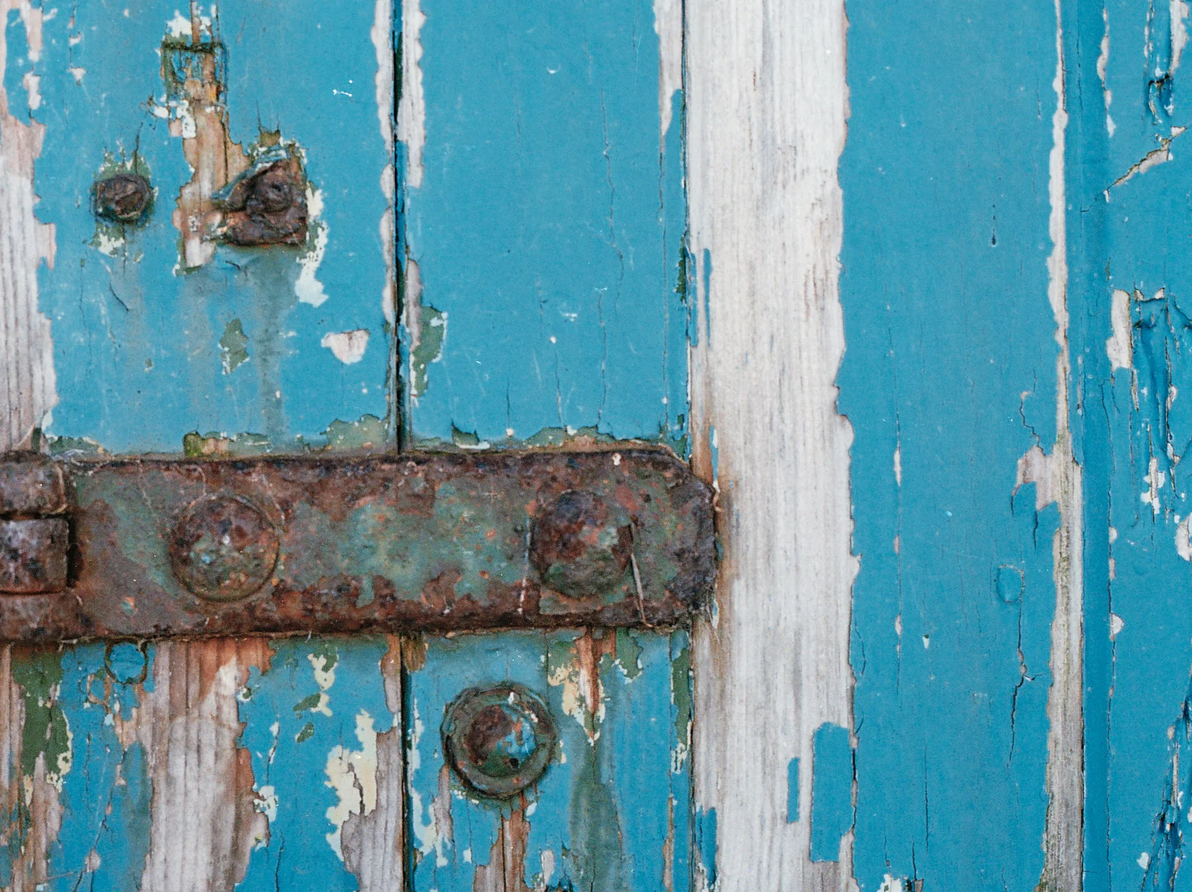  Metal plate corrosion on a long abandoned harbour building door. 