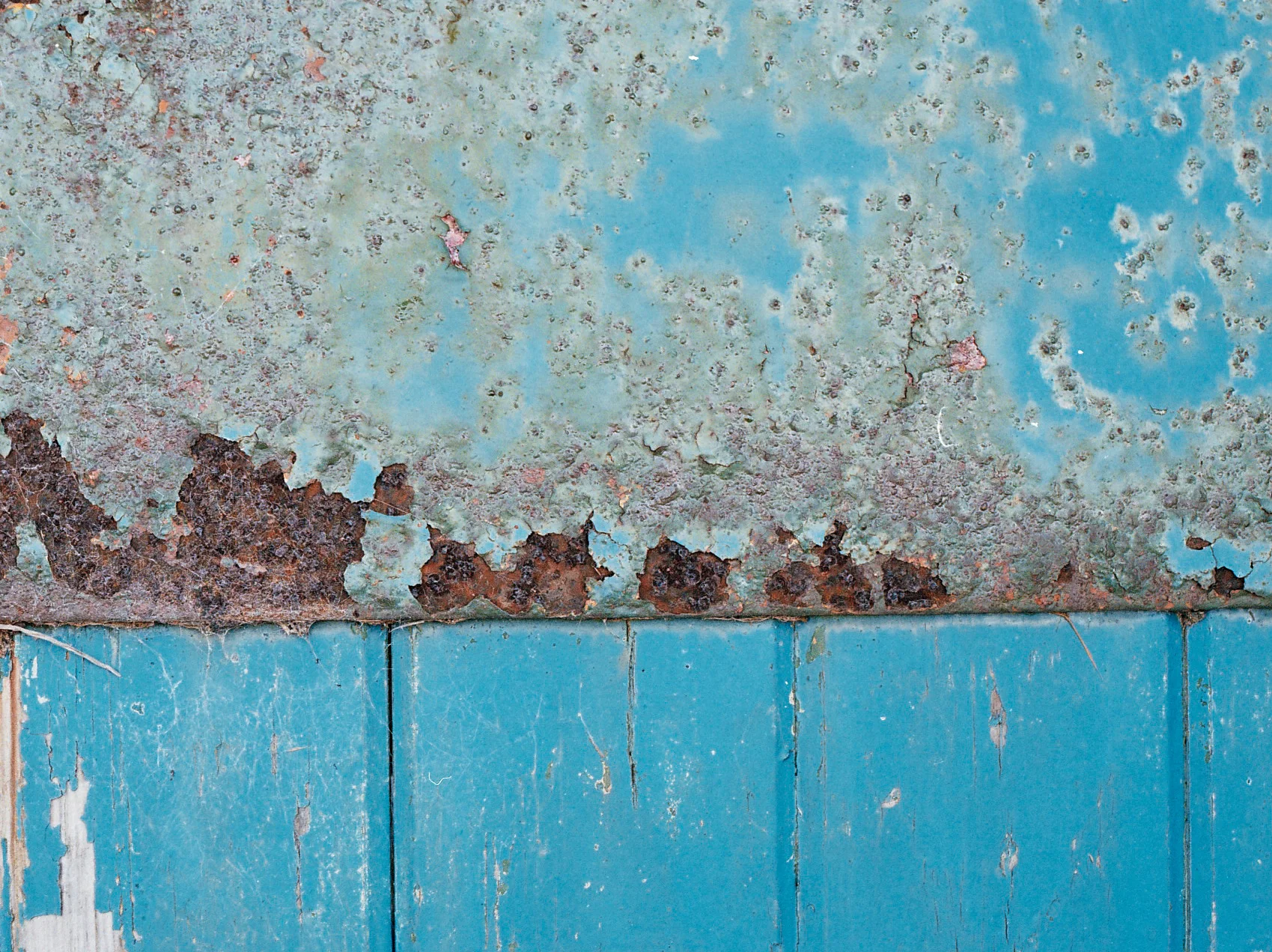  Metal plate corrosion on a long abandoned harbour building door. 