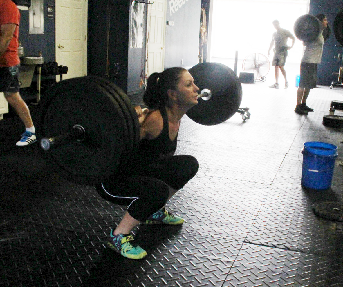 Melissa W at the bottom of a Back Squat