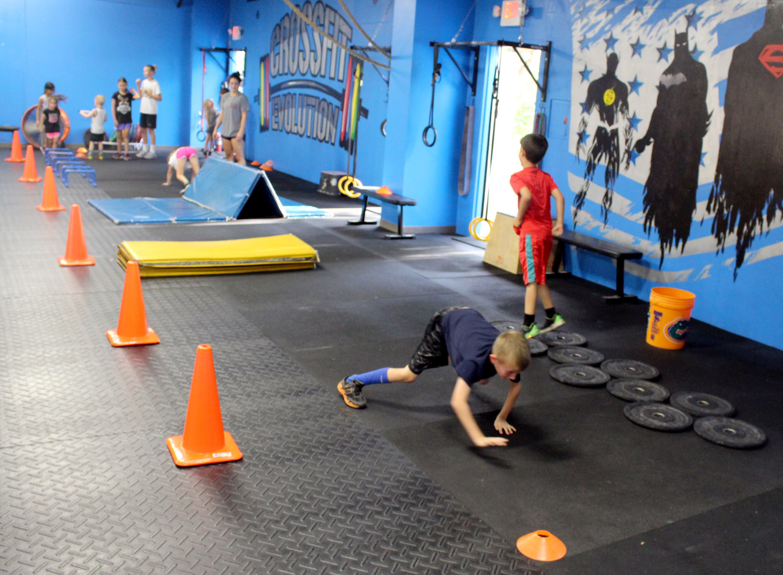 Kids warming up on an obstacle course.