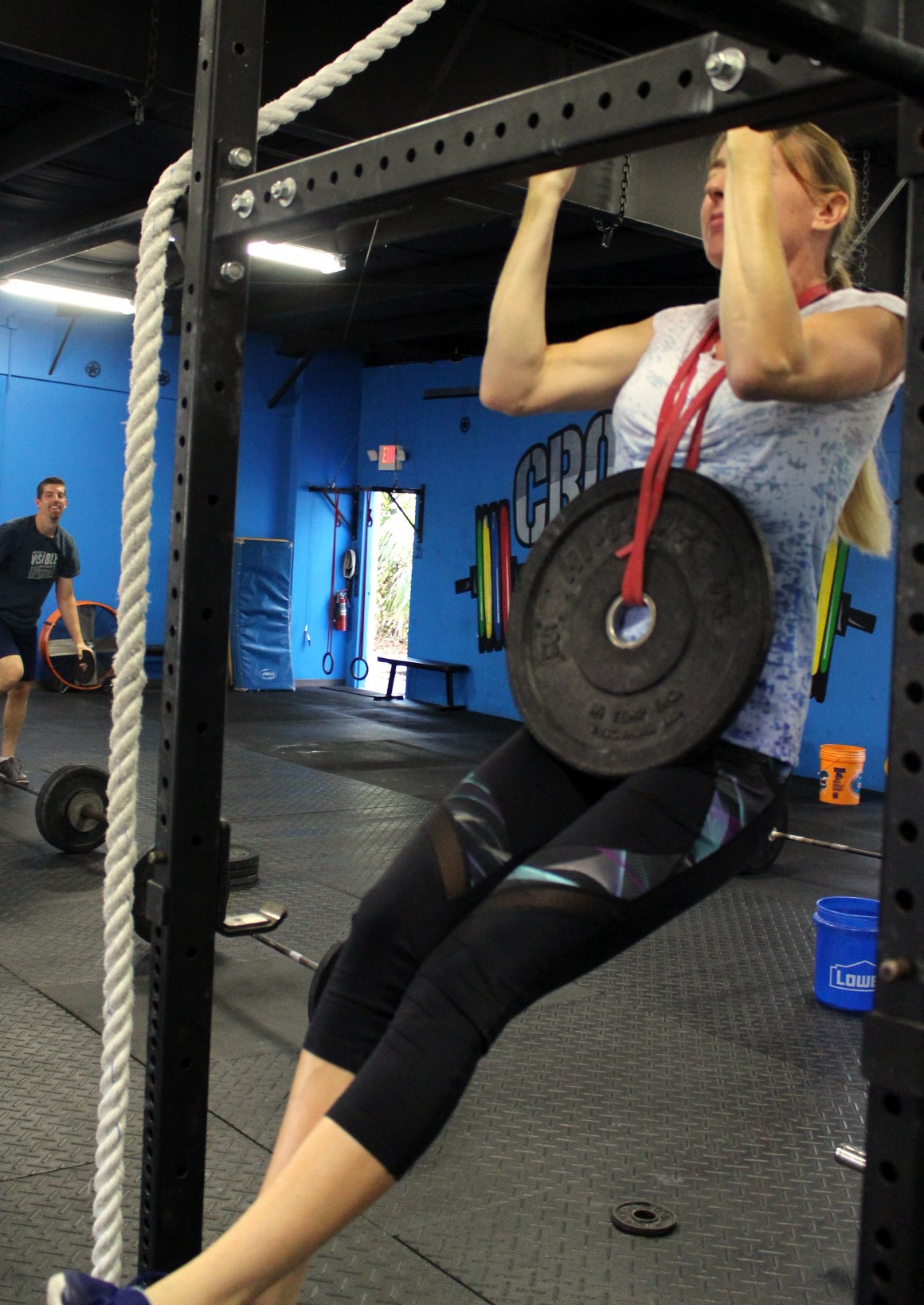 Tiffany doing weighted pull-ups