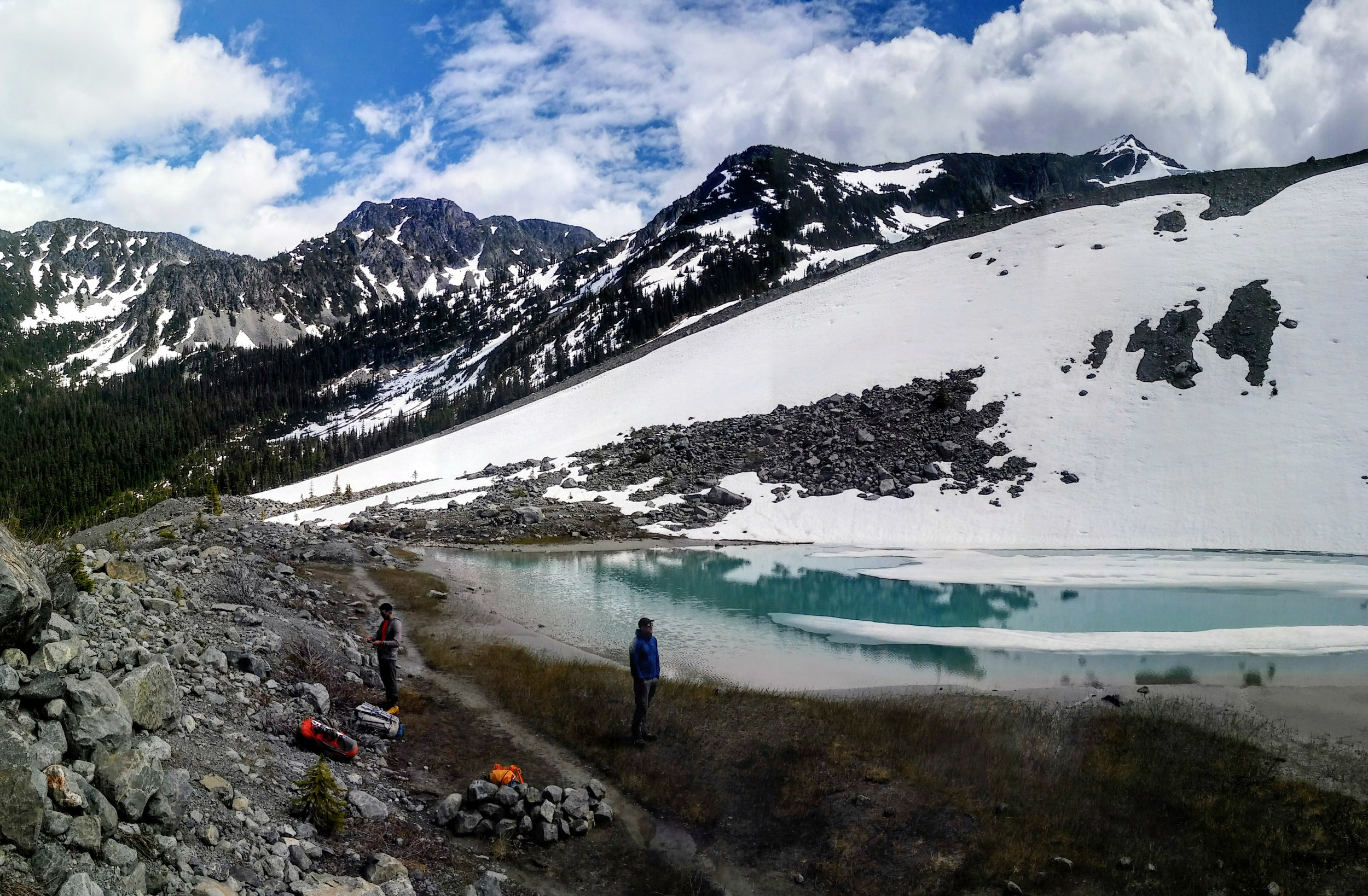 Camping by a glacial lake before climbing the next day. Matt is assessing the ascent.