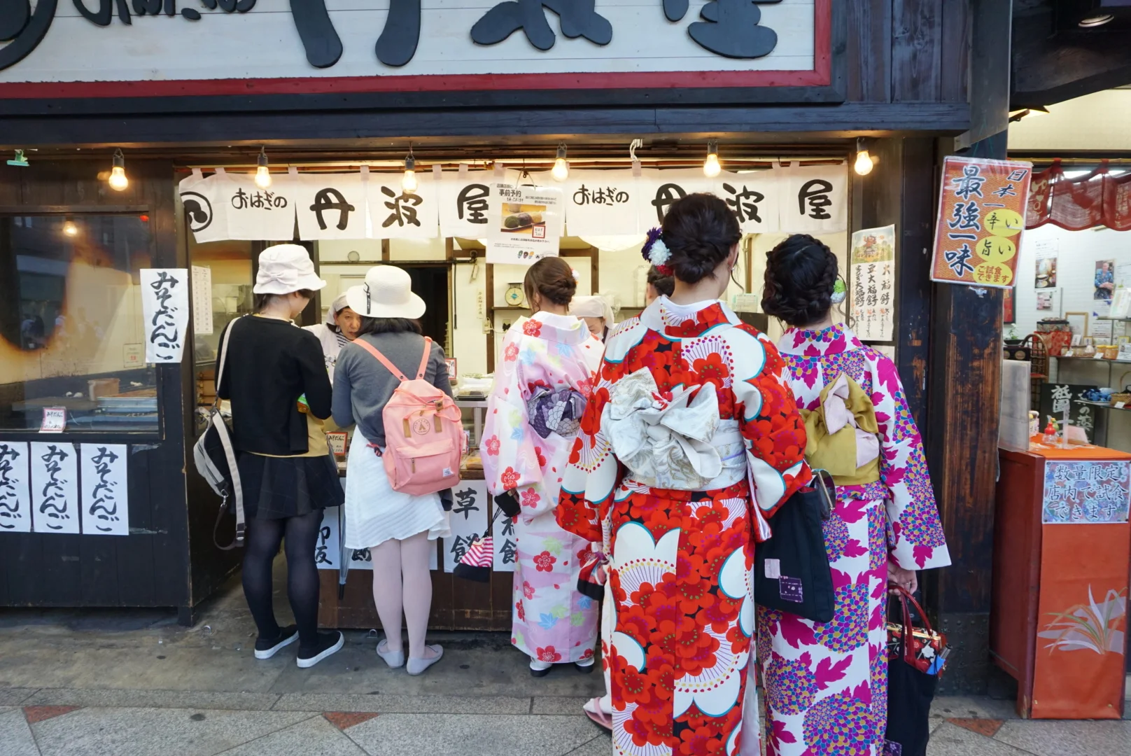 Gion area in Kyoto - great street food, small boutiques for shopping, and women in traditional garb. If you're lucky, you may see a real geisha in Hanami-koji.