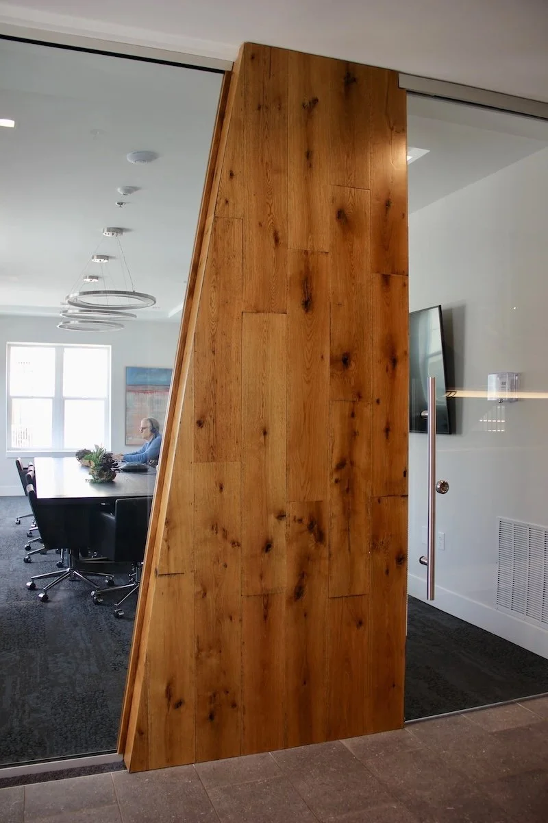 A wooden partition wall with a glass door in an office conference room.