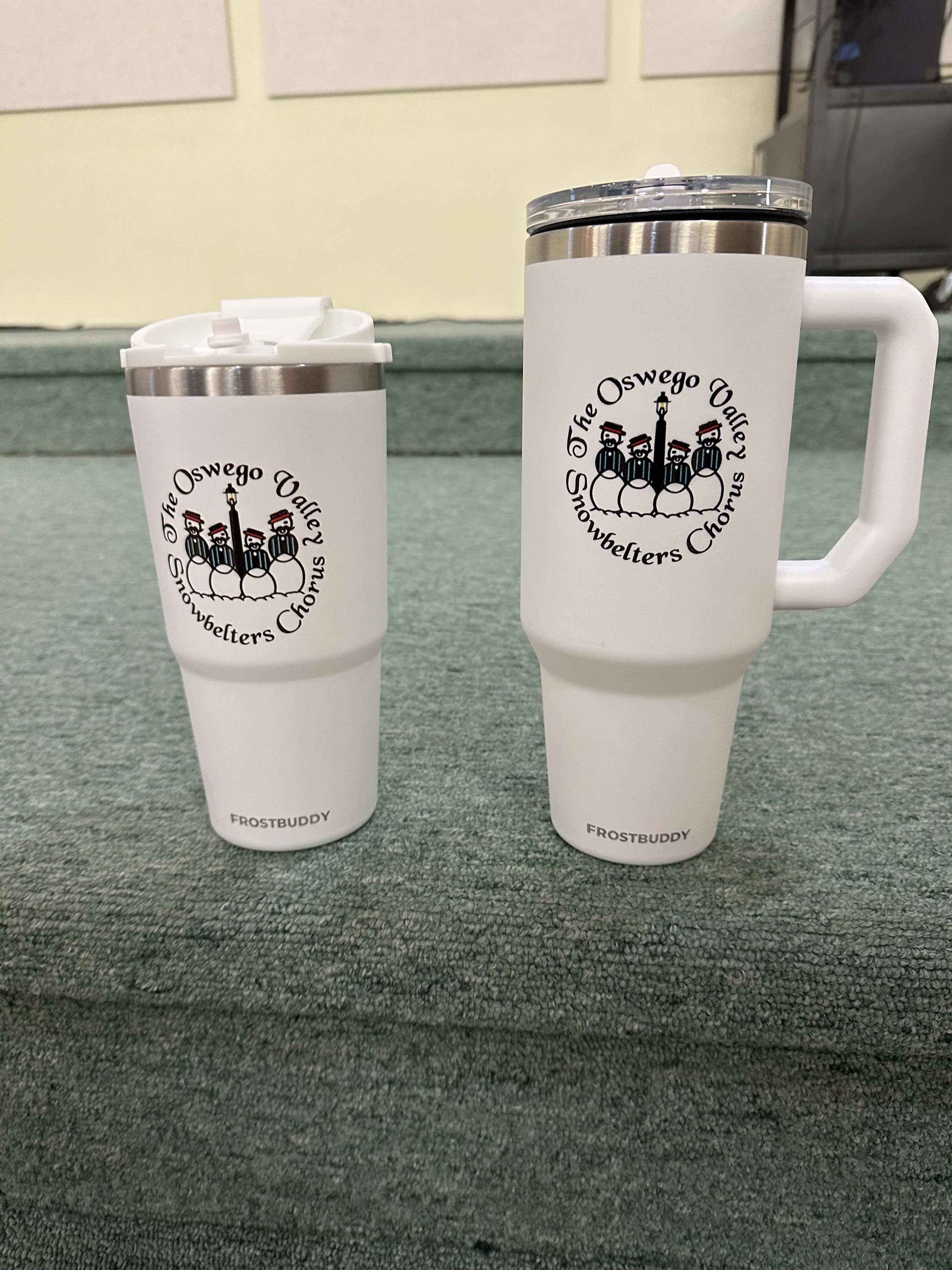 Two mugs on Carpet.  TO go buddy mug on left, THICC Buddy on right.