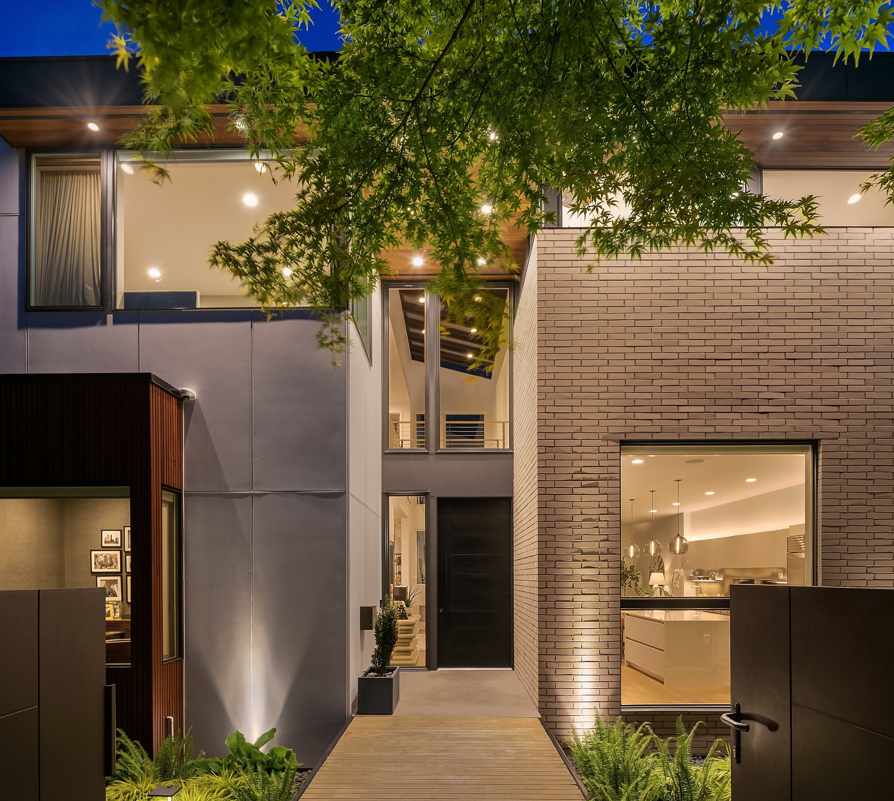  Here is the front of the home with the gated entrance (notice the two doors on either side of the photo), On either side of the walkway are beautifully landscaped gardens. 