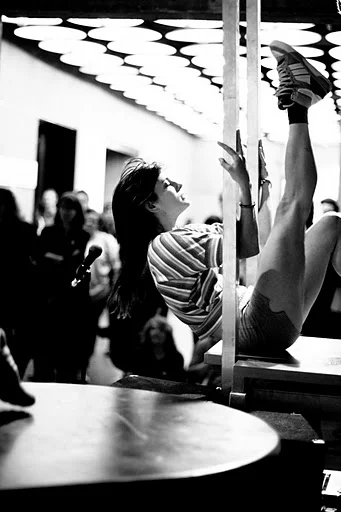 The Whitney offered me rehearsal time in the galleries during regular museum hours to prepare for my evening performance. Five dancers and I performed “rehearsal,” with me playing the enraged choreographer, screaming at the dancers and disturbing the impromptu audience. Later that night, five Whitney docents acted as low-tech karaoke leaders using lyrics written on posterboard. As the docents held up signs with five different Whitney Houston titles on them, the audience gathered around their favorite song title. A docent assistant captured the group’s rendition of the song on a walkie-talkie. Each of the five walkie-talkies had a sister walkie-talkie on each of the Whitney’s five floors. When the song is broadcast, one of the dancers from earlier broke into a solo dance in the middle of the galleries, performing for a new unsuspecting audience.