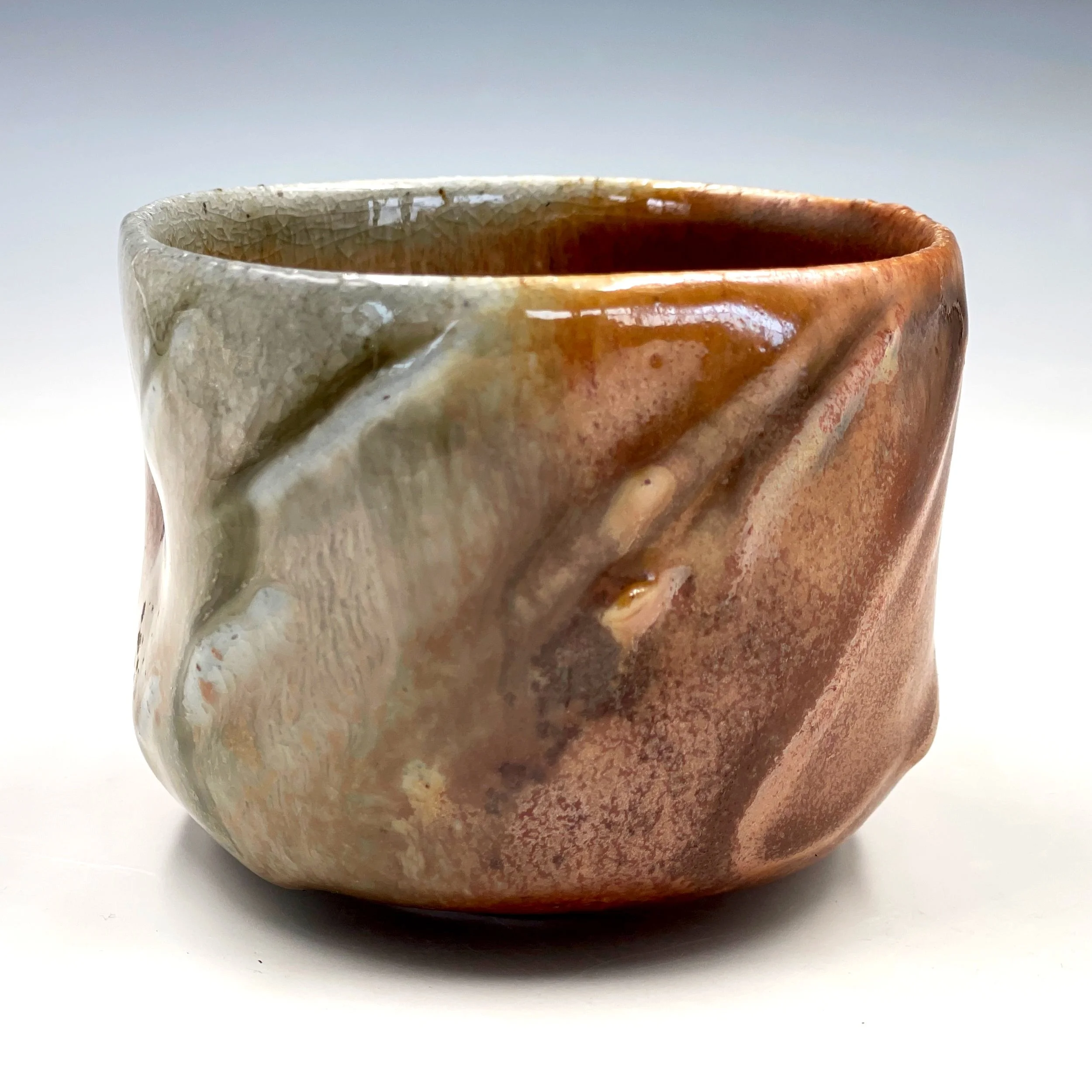 Ceramic tea cup with copper orange and faded teal blue color and textured lines. (Copy)