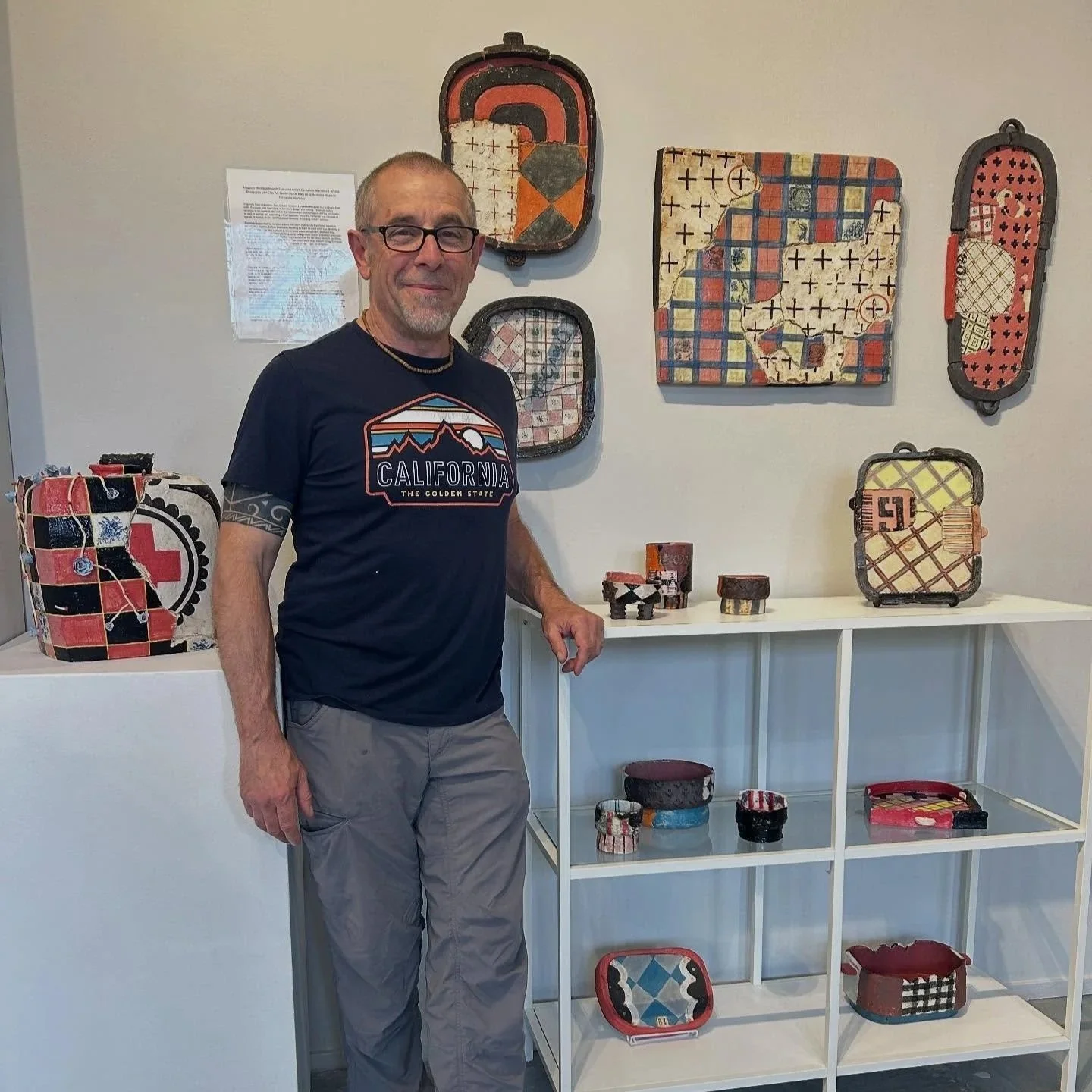 Fernando stands in front of his shop installation