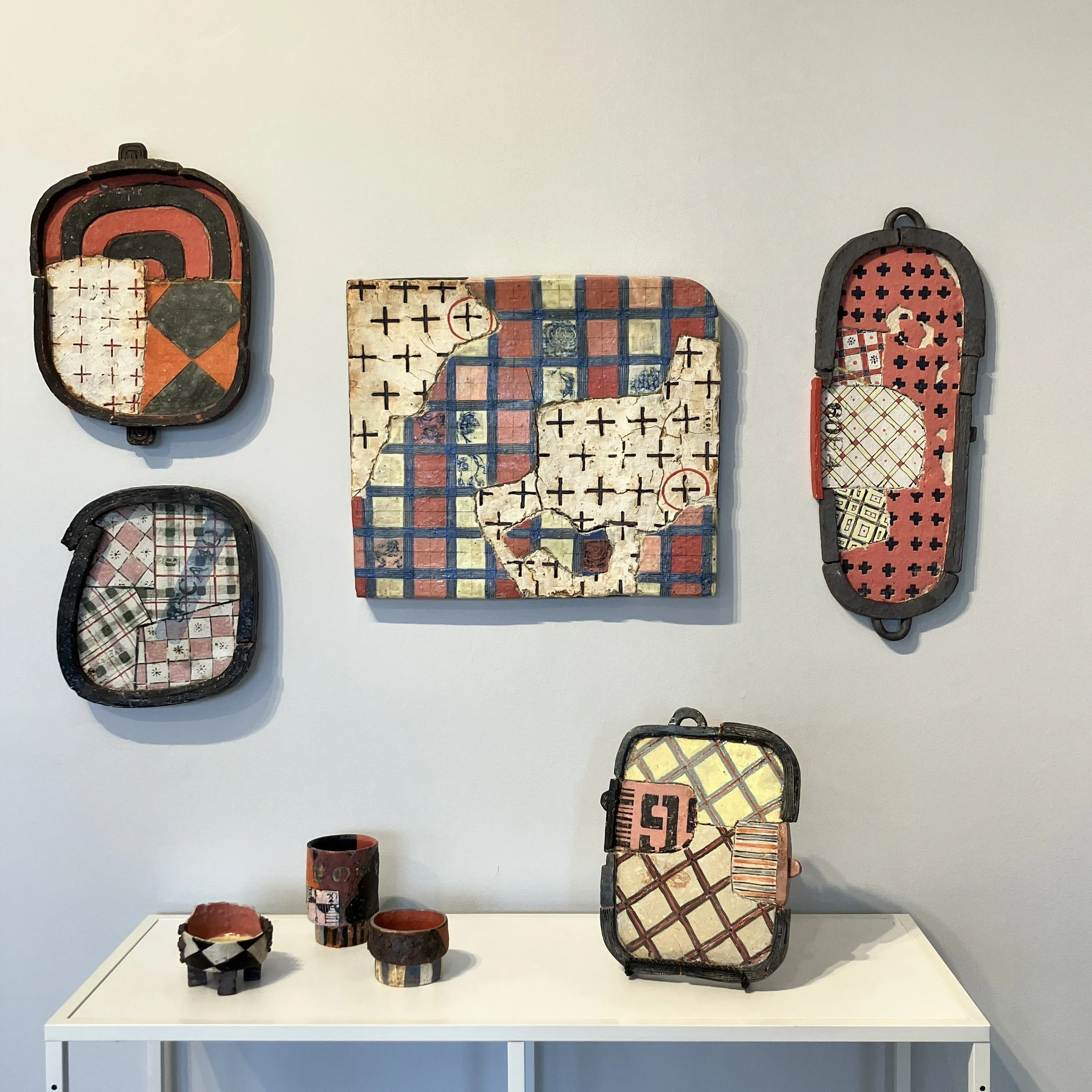 Fernando's Shop installation, including five wall hangings and three cups