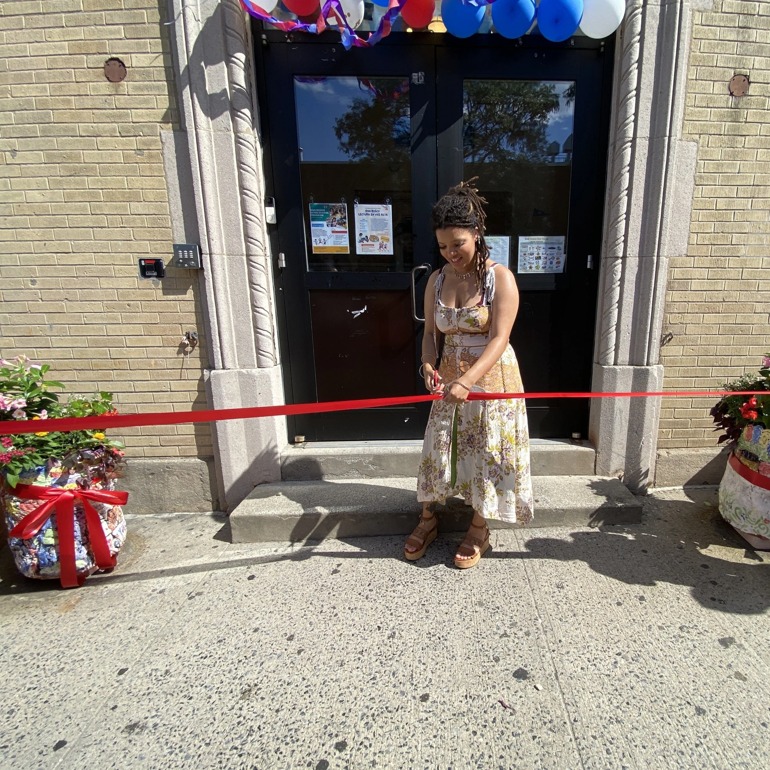 Evelyn cuts the ribbon to officially install the planters.
