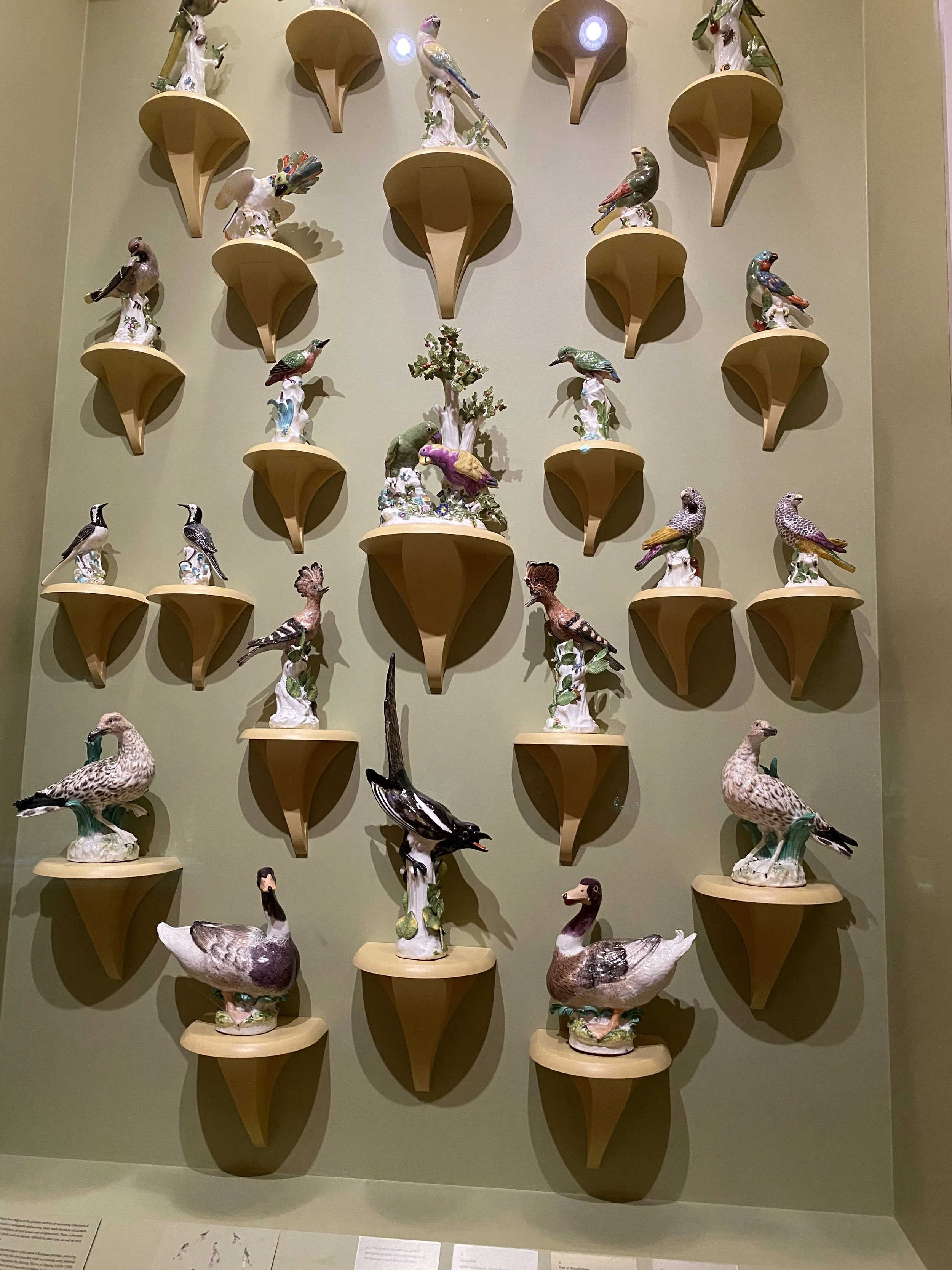 A wall of ceramic bird statues in the Metropolitan Museum