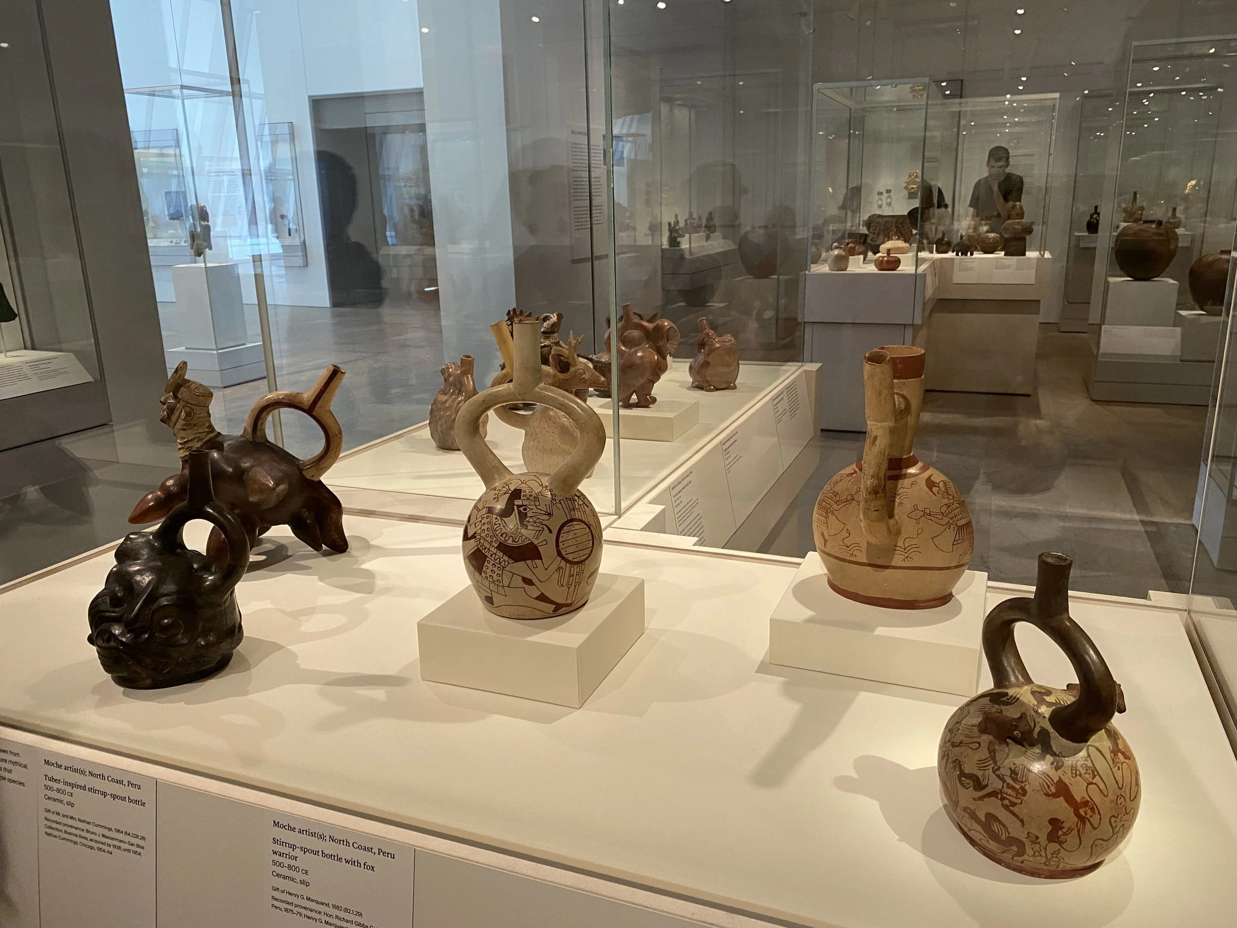 A group of five historic pots in a case at the Metropolitan Museum