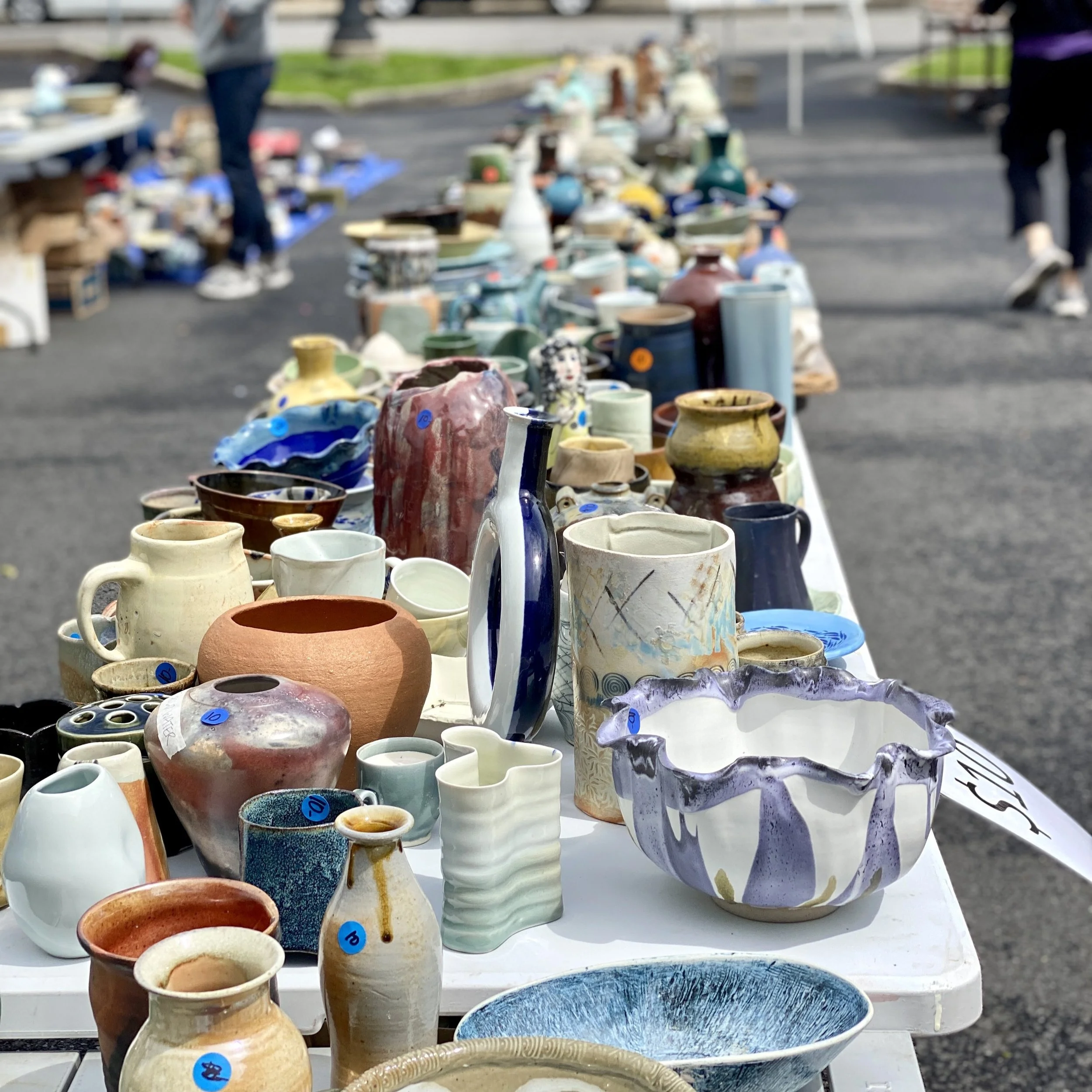 Tables full of pottery for outdoor pottery sale