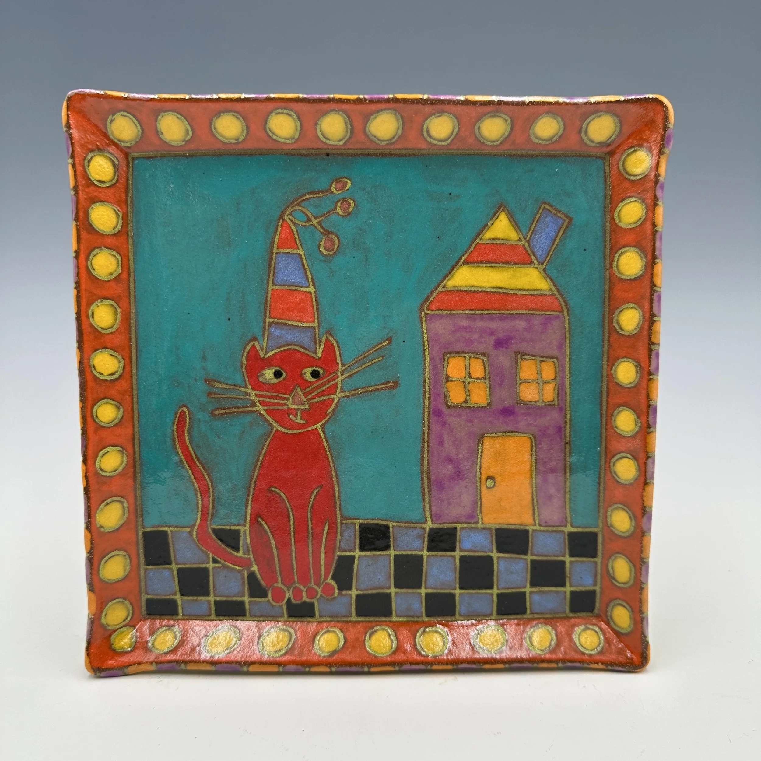 Plate Cat Sitting Next to House .JPG