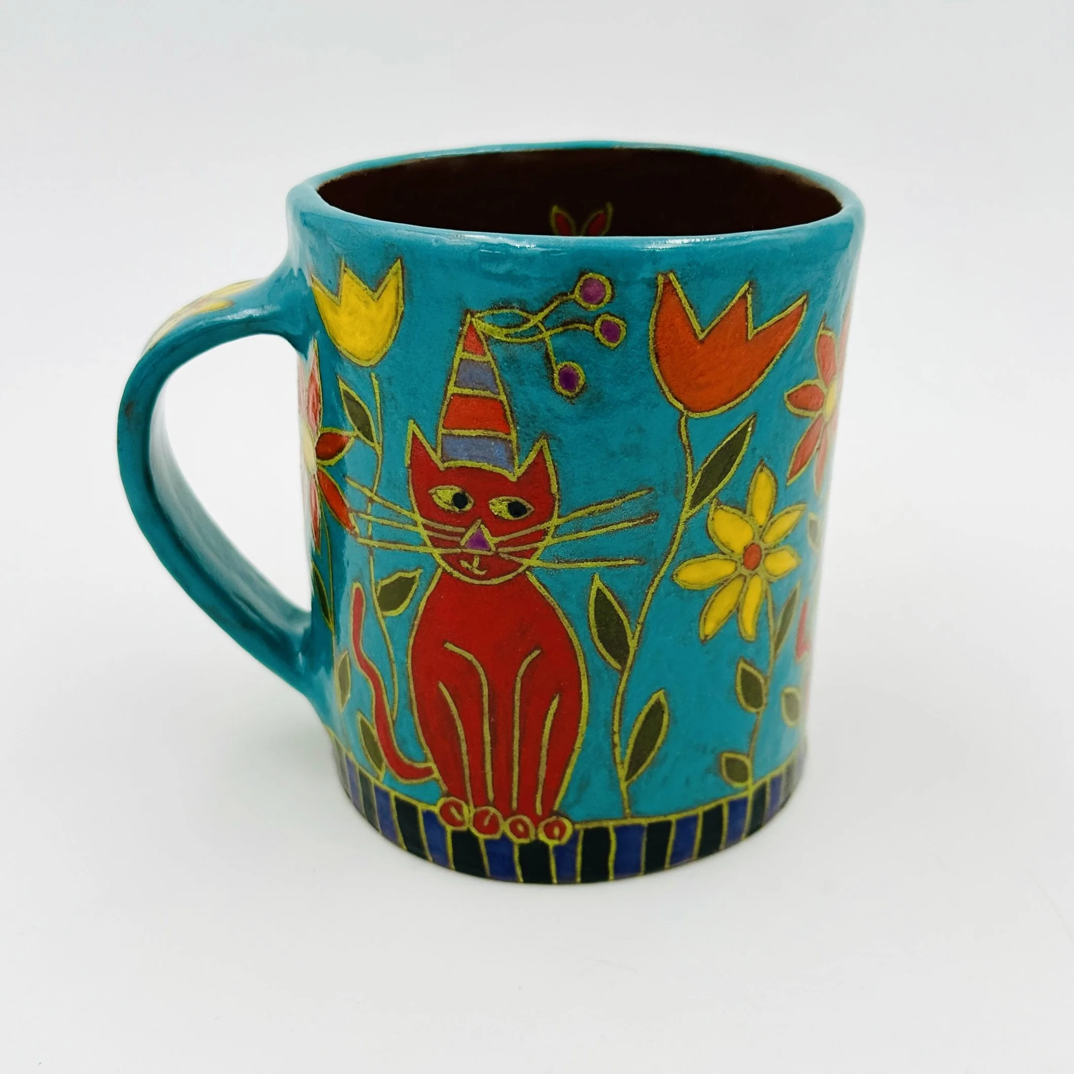 Red Cat Sitting in Flowers 1.JPG