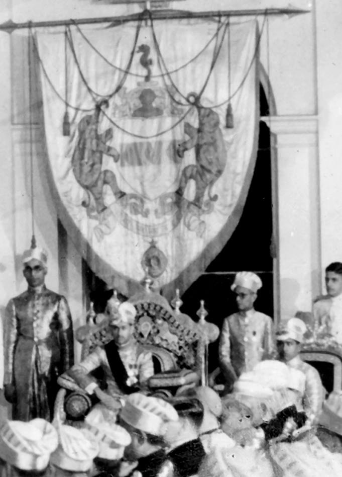 Birthday Durbar of Maharaja Chithira Thirunal Balarama Varma, c.1930s. In the background, the royal banner presented to Maharaja Ayilyam Thirunal Rama Varma in 1877.