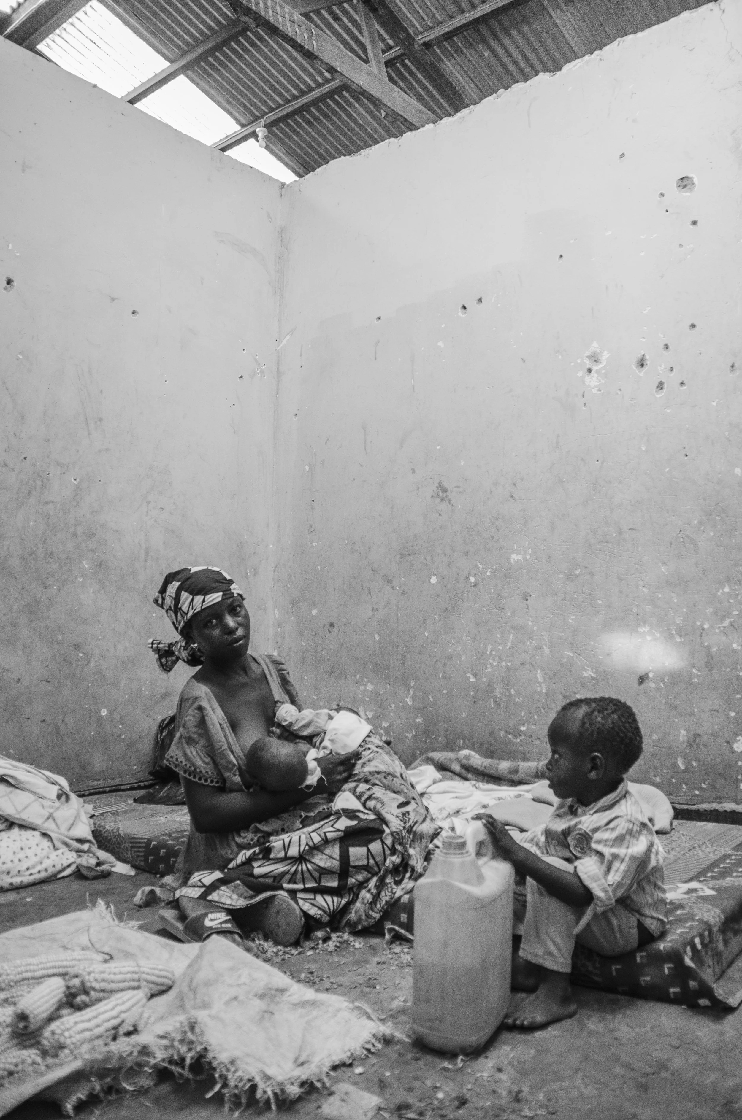 (Nayigiziki and her three boys from Burundi, Reception Centre, Nakivale Refugee Settlement)