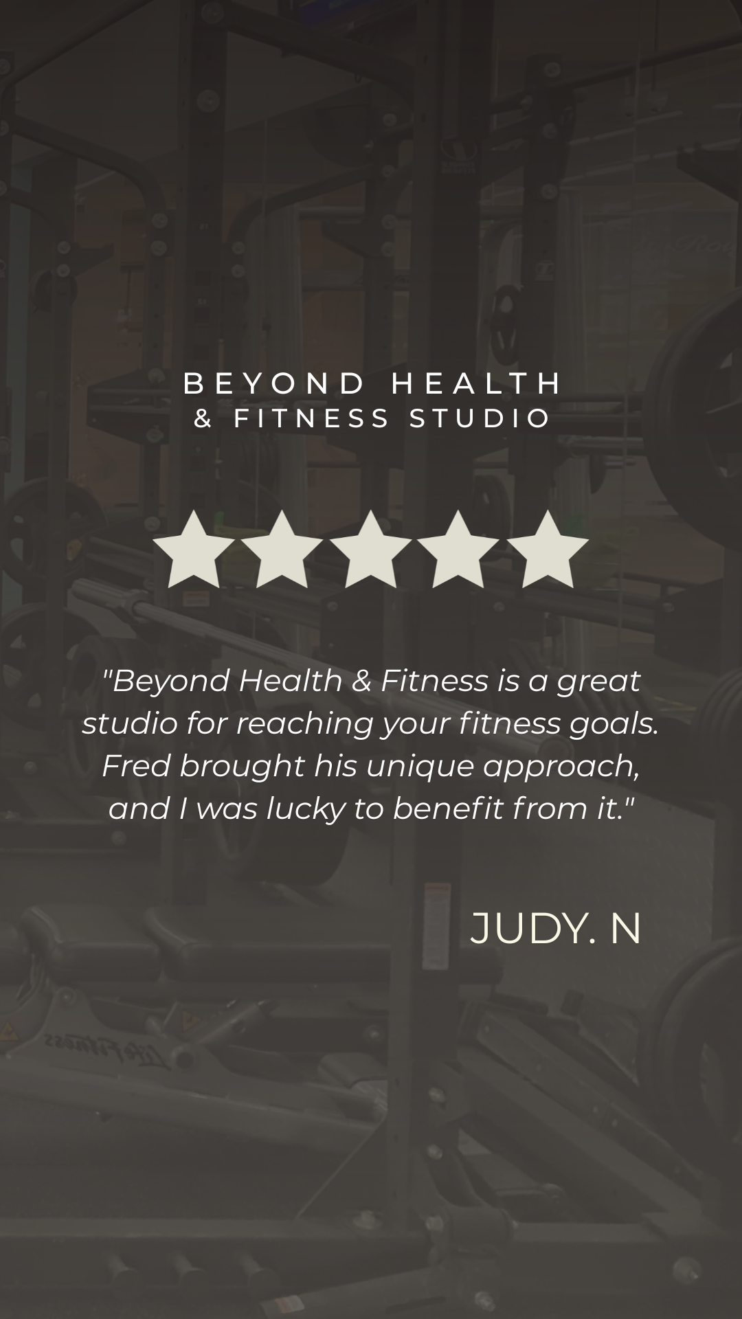 Glass door reflecting gym equipment inside Beyond Health & Fitness Studio, with text overlay of a five-star review and a quote from Judy N praising the studio.