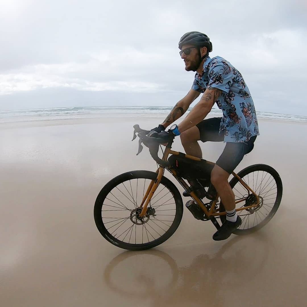 Riding bikes on the beach in the rain. Because why not?