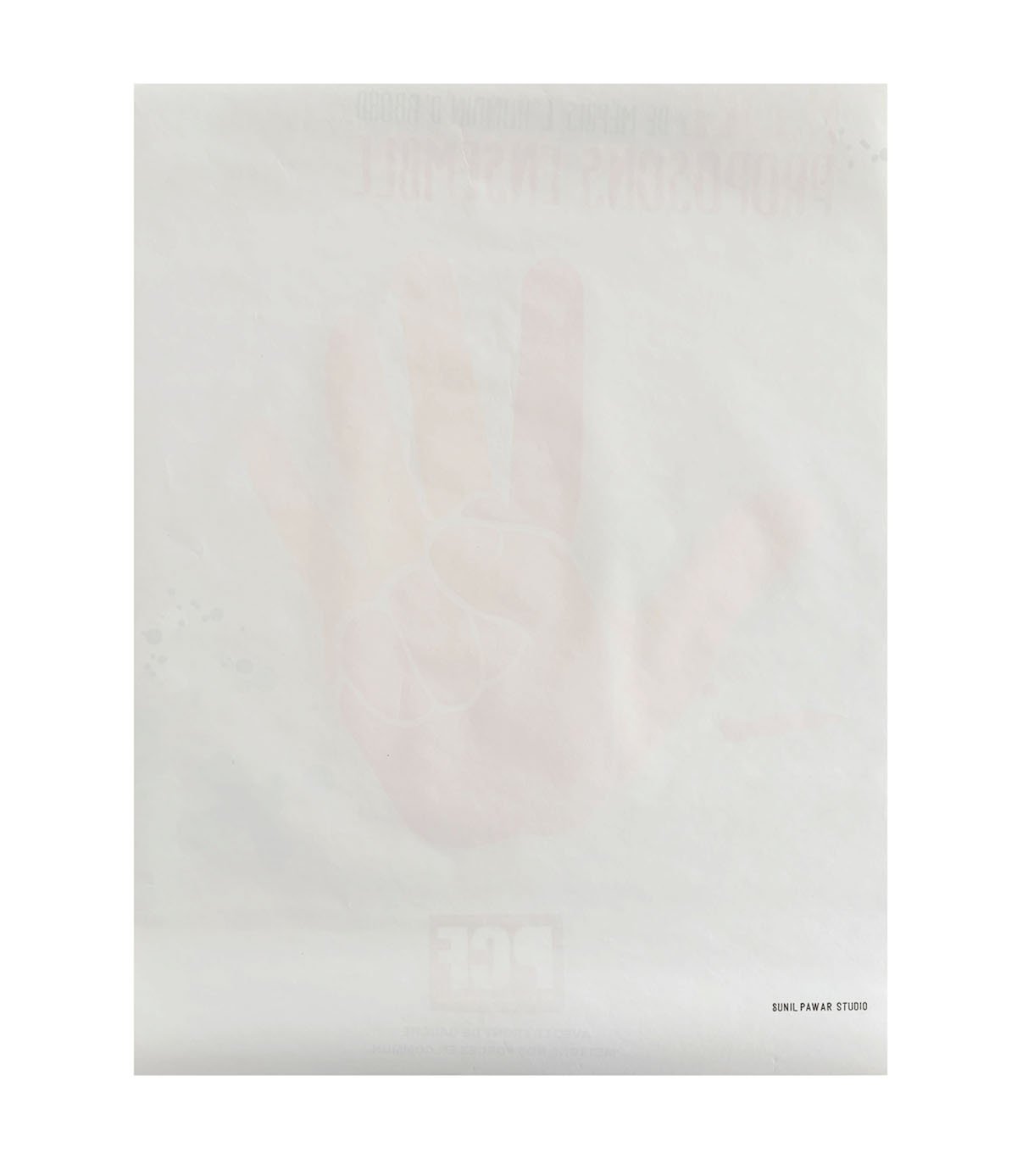 A white piece of paper with a faint hand making a rock and roll gesture. Text is barely visible in the background, and there is a small credit line that says "Sunil Pawar Studio" at the bottom right corner.