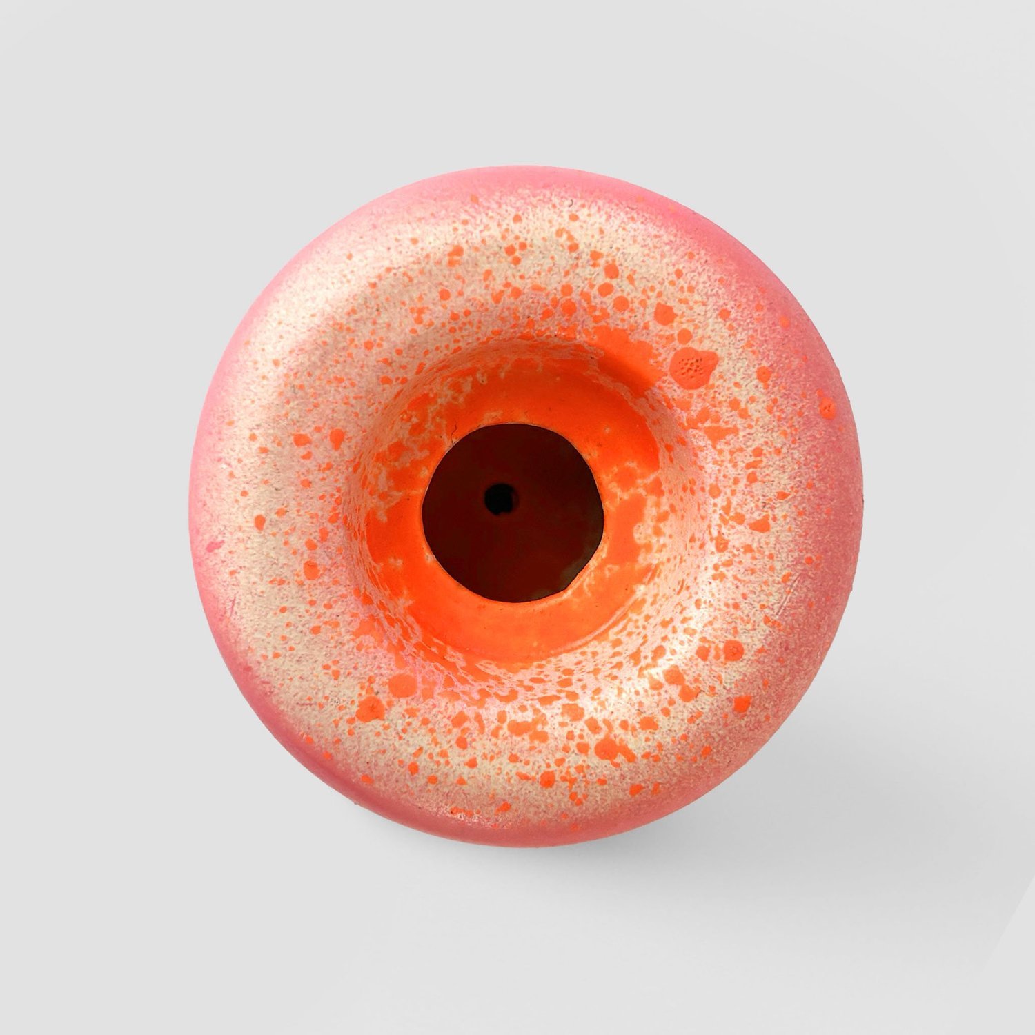 Close-up of a pink and orange rubber duck toy viewed from above.