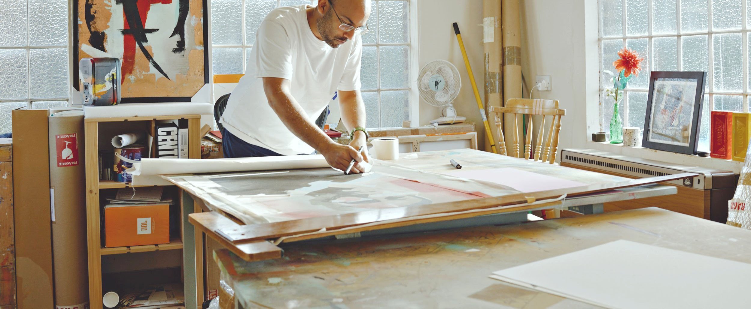 Sunil Pawar in Art studio with paintings and art materials