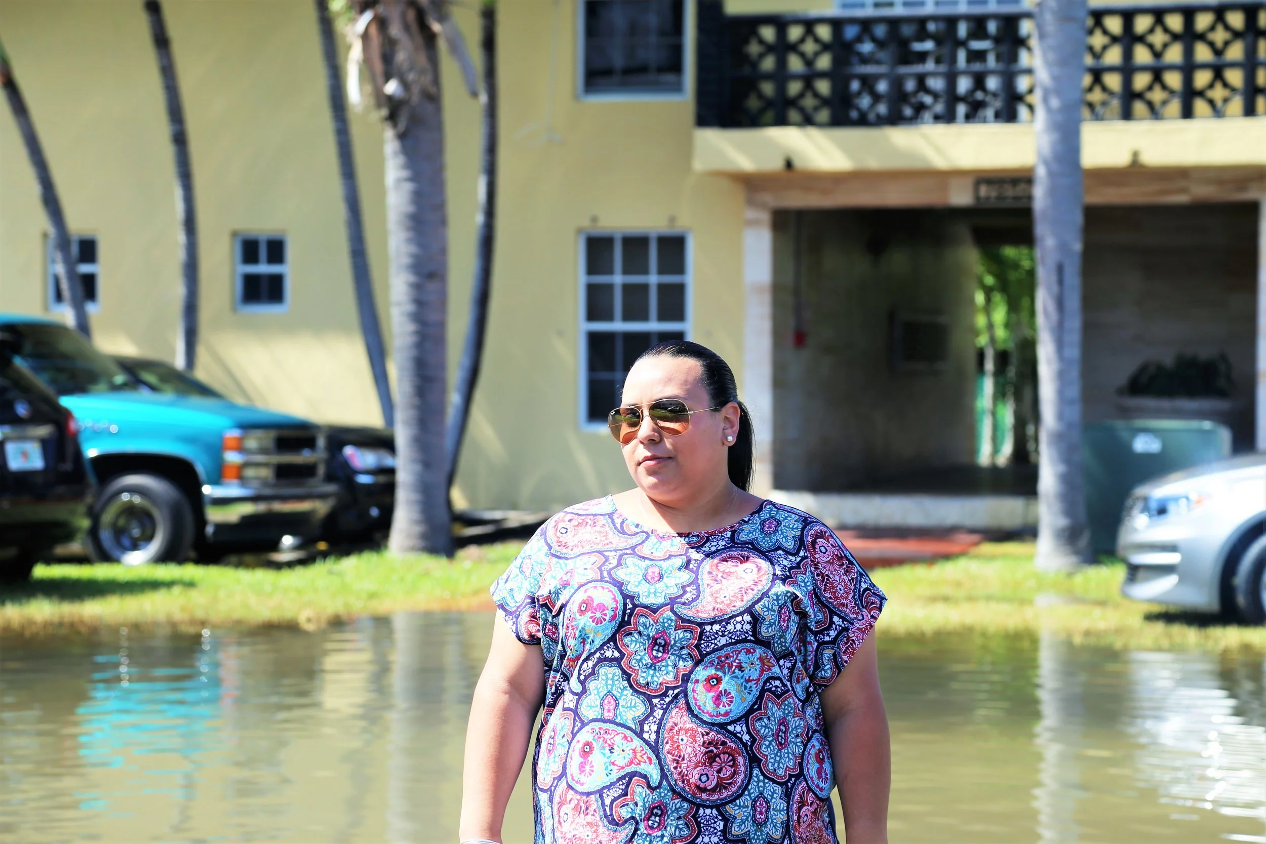 Karina during king tides in October of 2016 outside an apartment building in the community of Shorecrest, Miami. Photo: Dayna Reggero, Climate Listening Project.