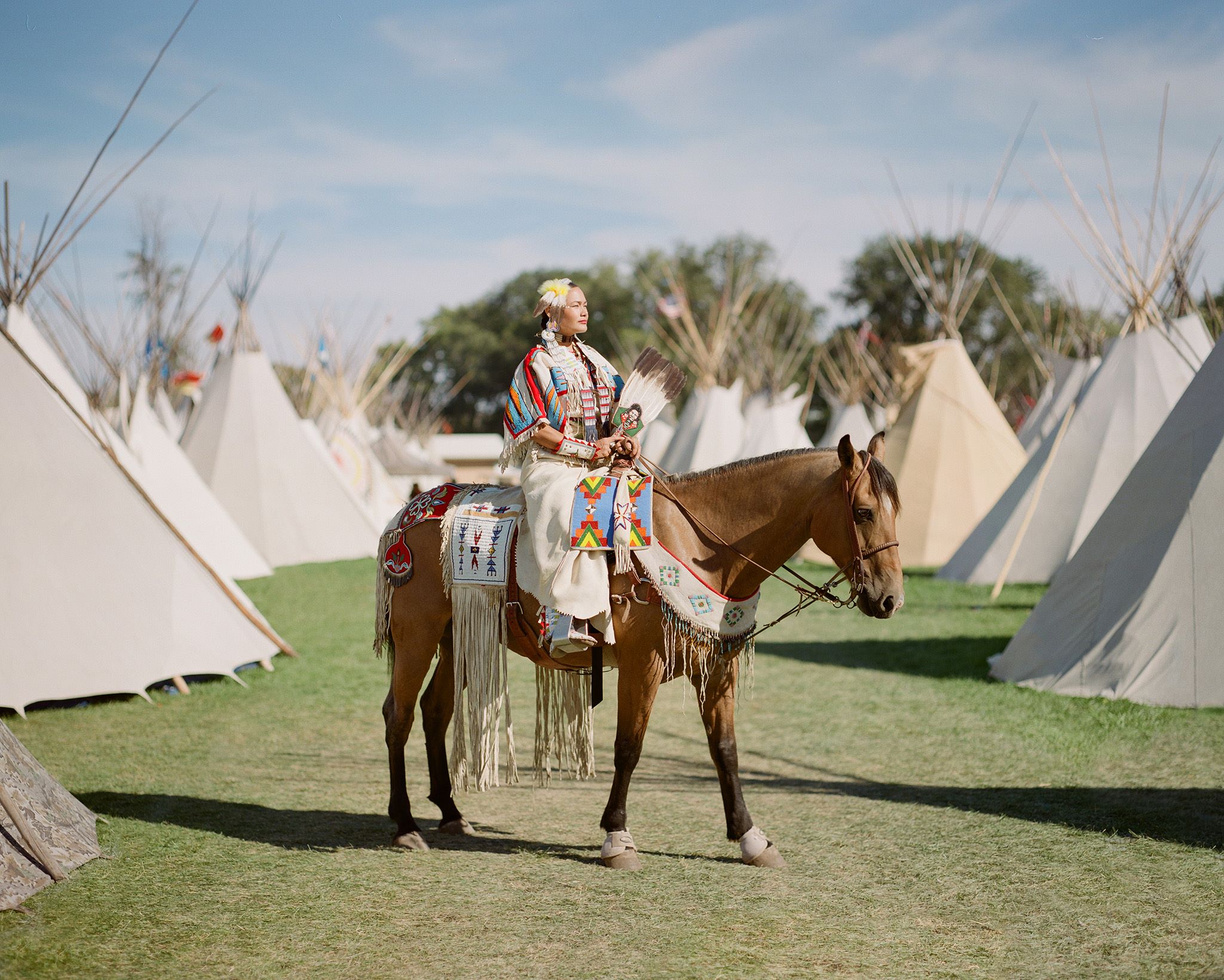 This is my favorite shot of the year. I ran into my friend here on her horse surrounded by a crowd. I had 2 shots left on my roll of film. I asked if I could take her photo and for one second, the crowd happened to be out of the frame. A magical moment for me. - Whitney Minthorn 