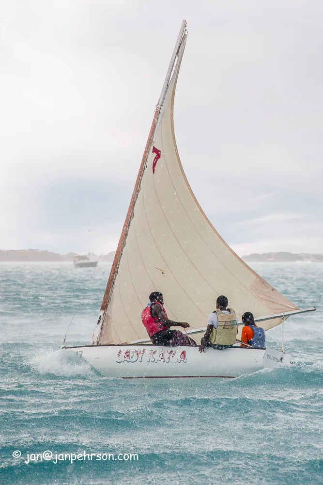 April 2019, George Town, Exuma, Bahamas, Exuma Sailing Club Regatta, E-Class Sloop "Lady Kayla" sails through a rain squall