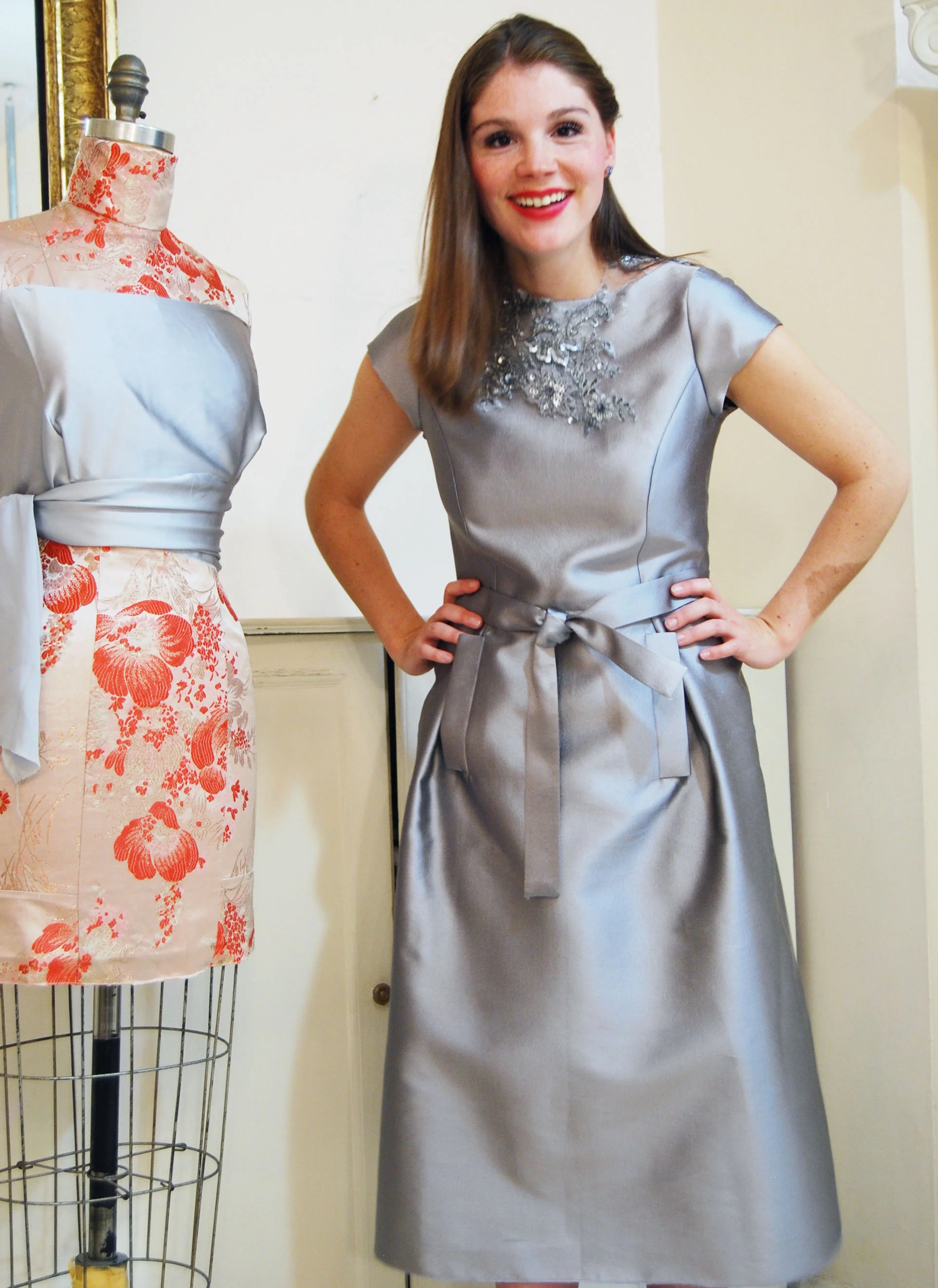 Silver silk/wool blend. with pockets and tie belt. Lace necklace is separate from the dress.
