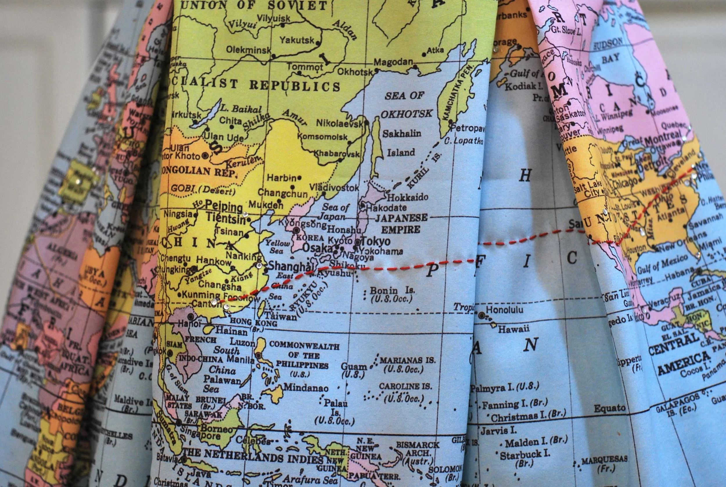 Sadie was born in China and we used a red embroidered line to mark her journey from her birthplace to her new home in New York city. Tiny crystals mark all the places mother and daughter have visited together.