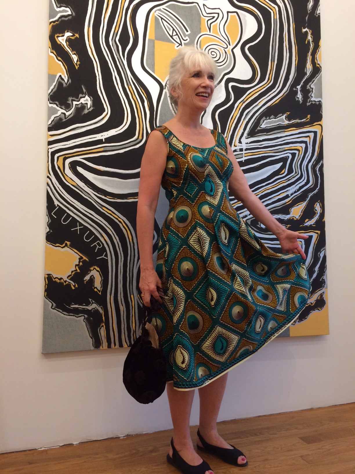 Devin Dougherty in Elizabeth Cannon Wax-print dress in front of Josh Abelow painting photo: Taro Suzuki